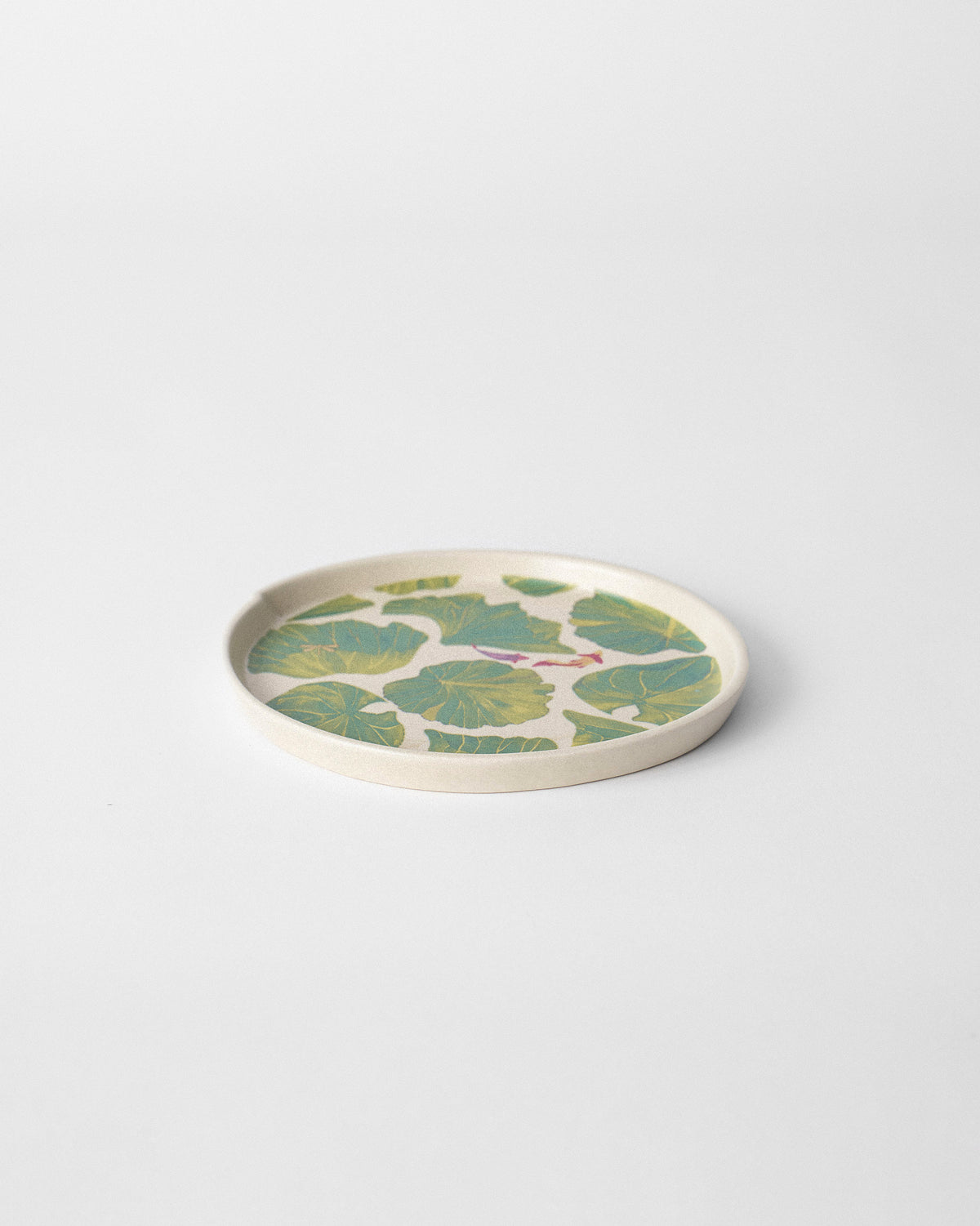 Lily Pond dessert plate with green lily-pad leaves on cream stoneware.