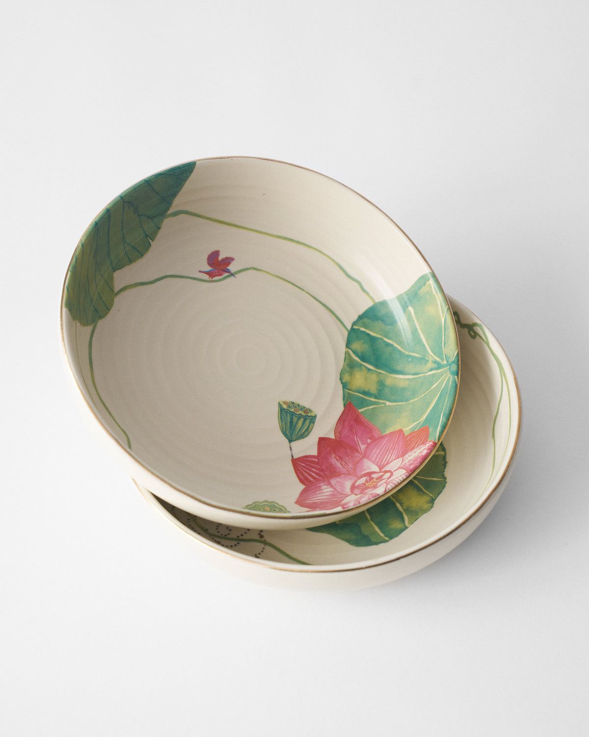 Stacked Lotus Garden shallow bowls with lotus, leaves, and a bird.
