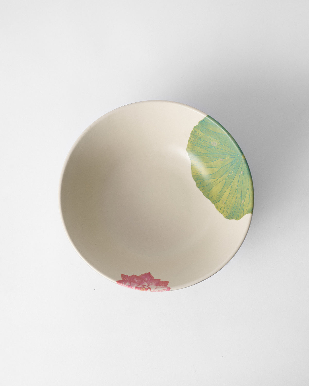 Overhead view of Lotus Garden curry bowl with lily pad and pink lotus.