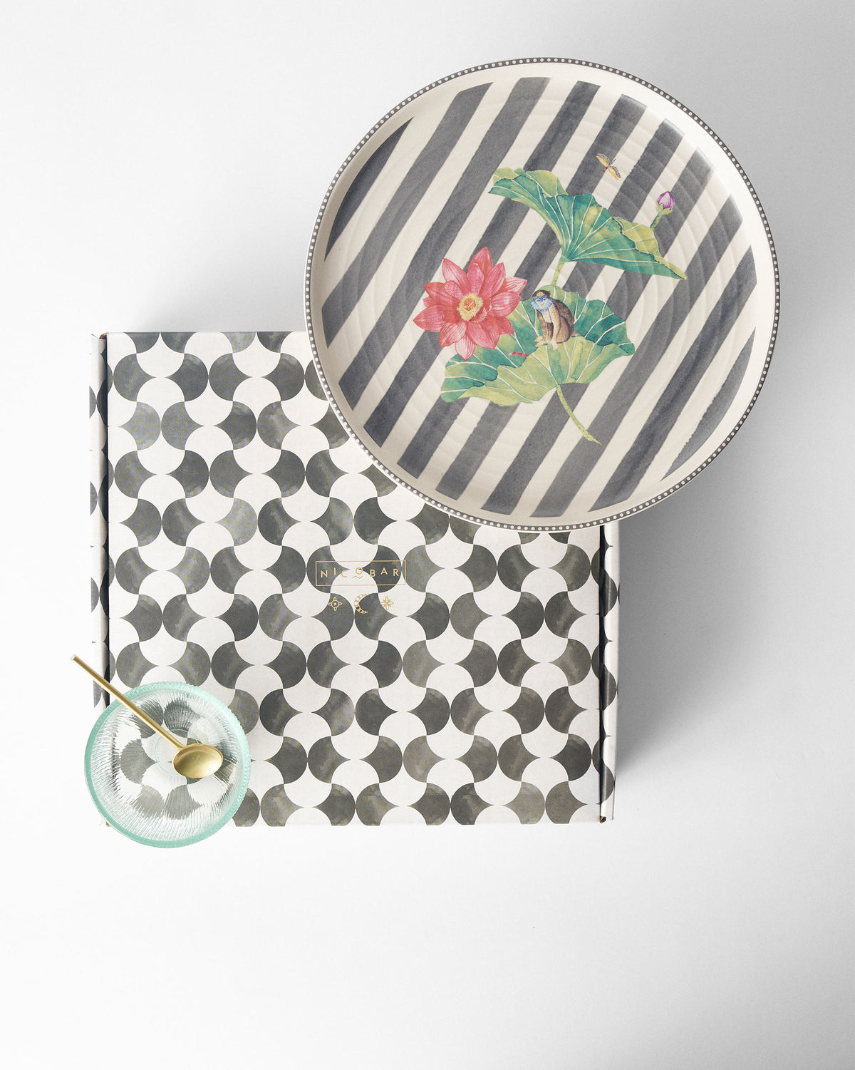 Lily Pond platter with lotus print beside a Nicobar gift box.