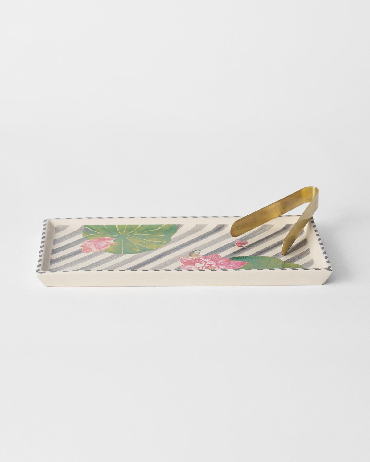 Charcoal Lotus Garden cookie tray with pink lotuses and brass tongs.
