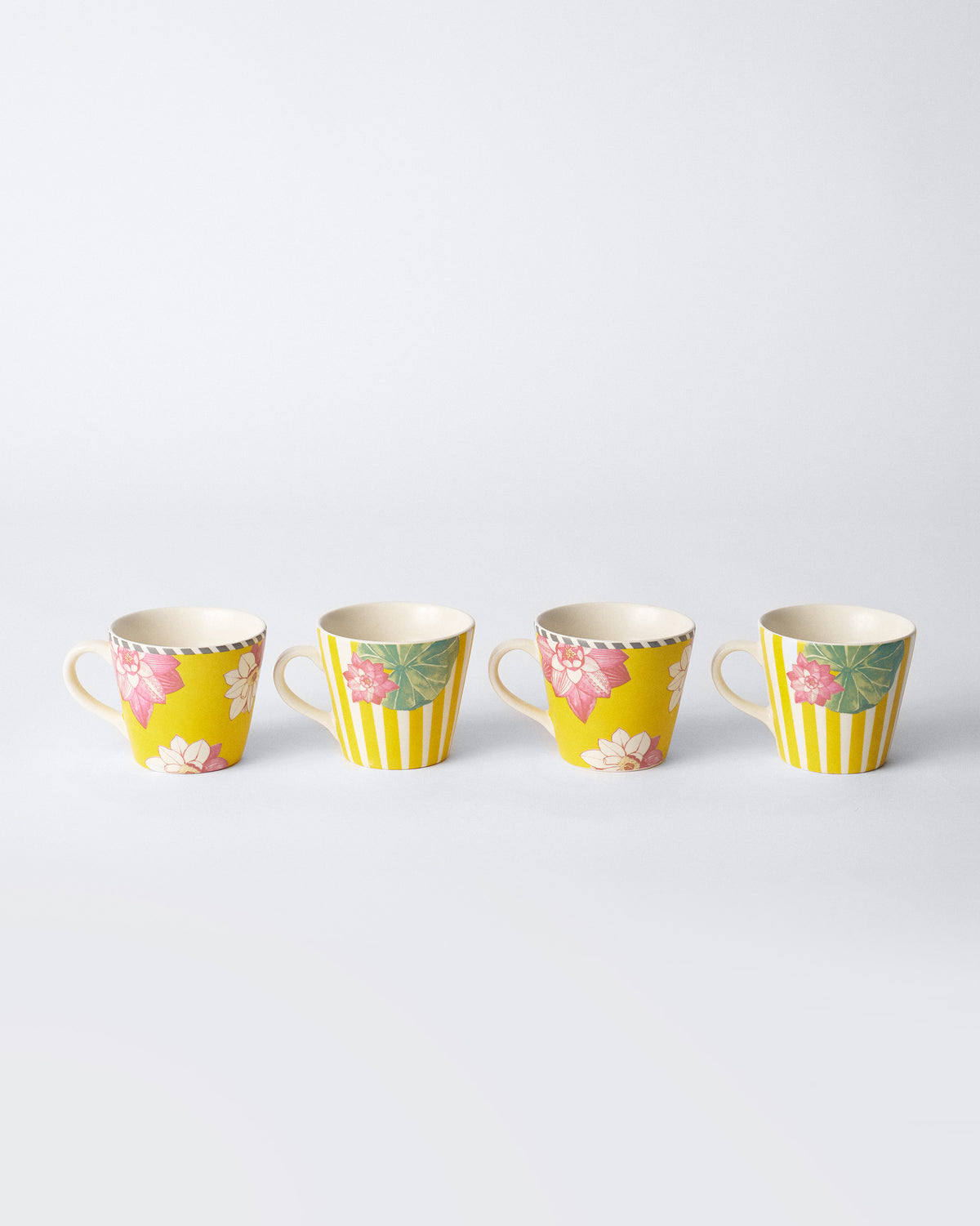 Row of four Lotus Garden espresso mugs in yellow lotus prints.