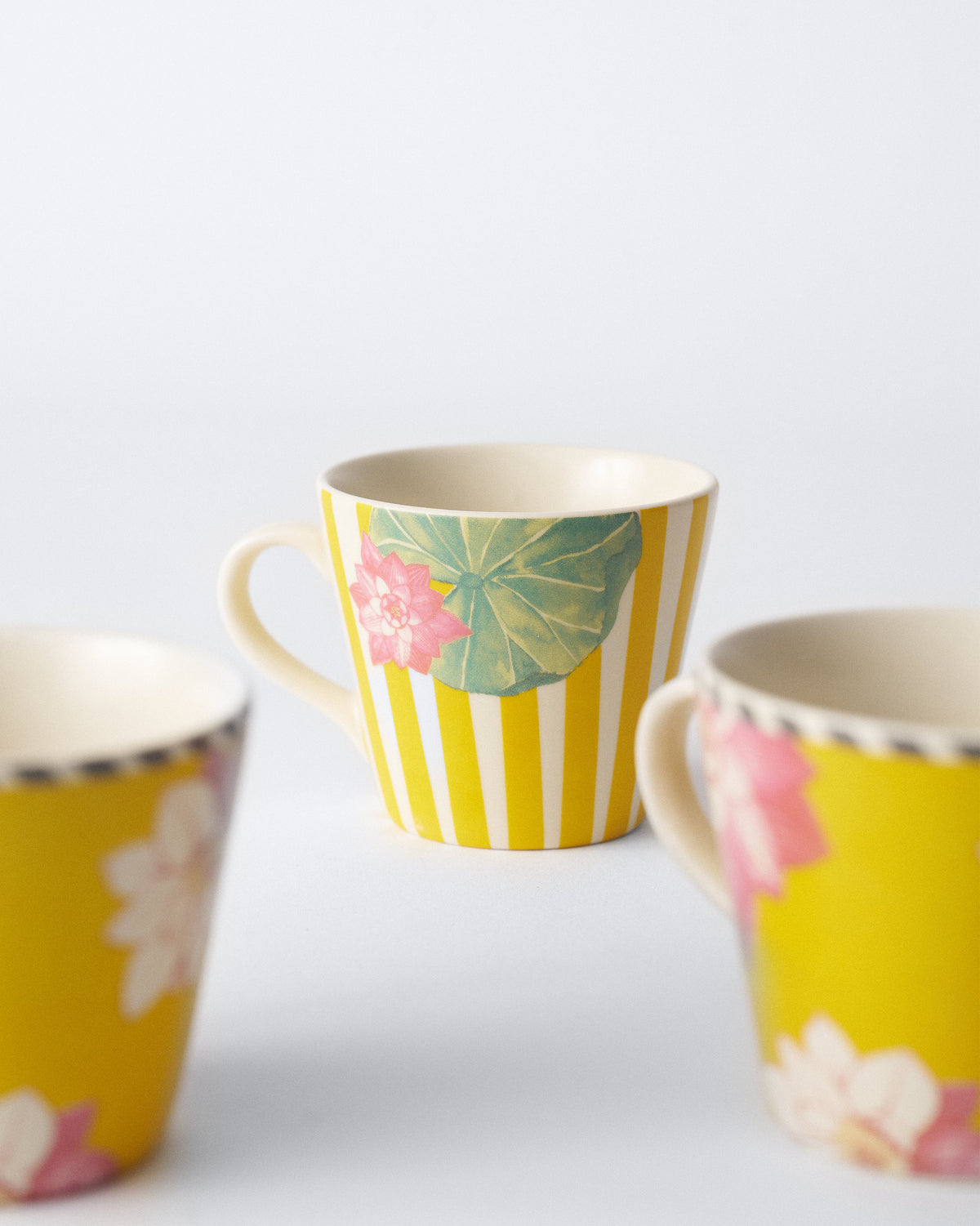 Lotus Garden espresso mug with yellow stripes and a green lily pad.