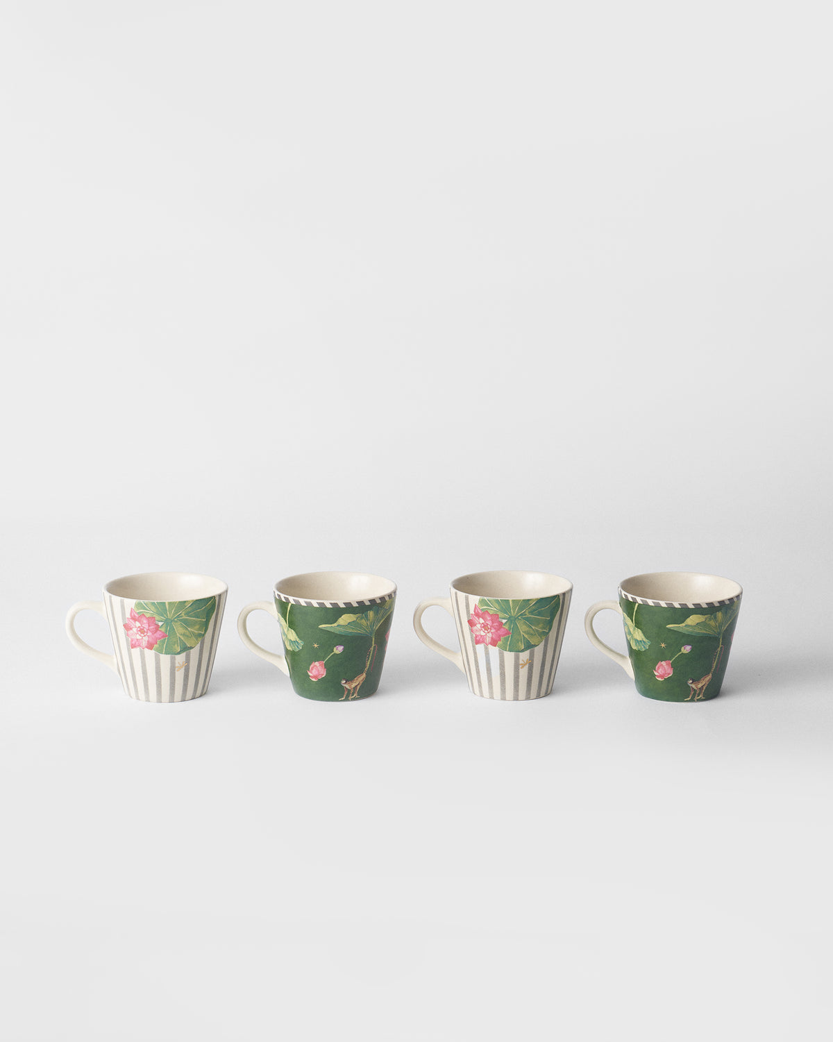 Row of four Float espresso mugs in green and striped lotus prints.