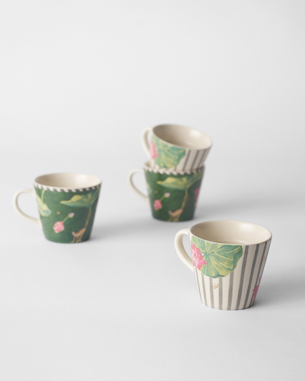 Float espresso mugs arranged to show green and striped lotus designs.