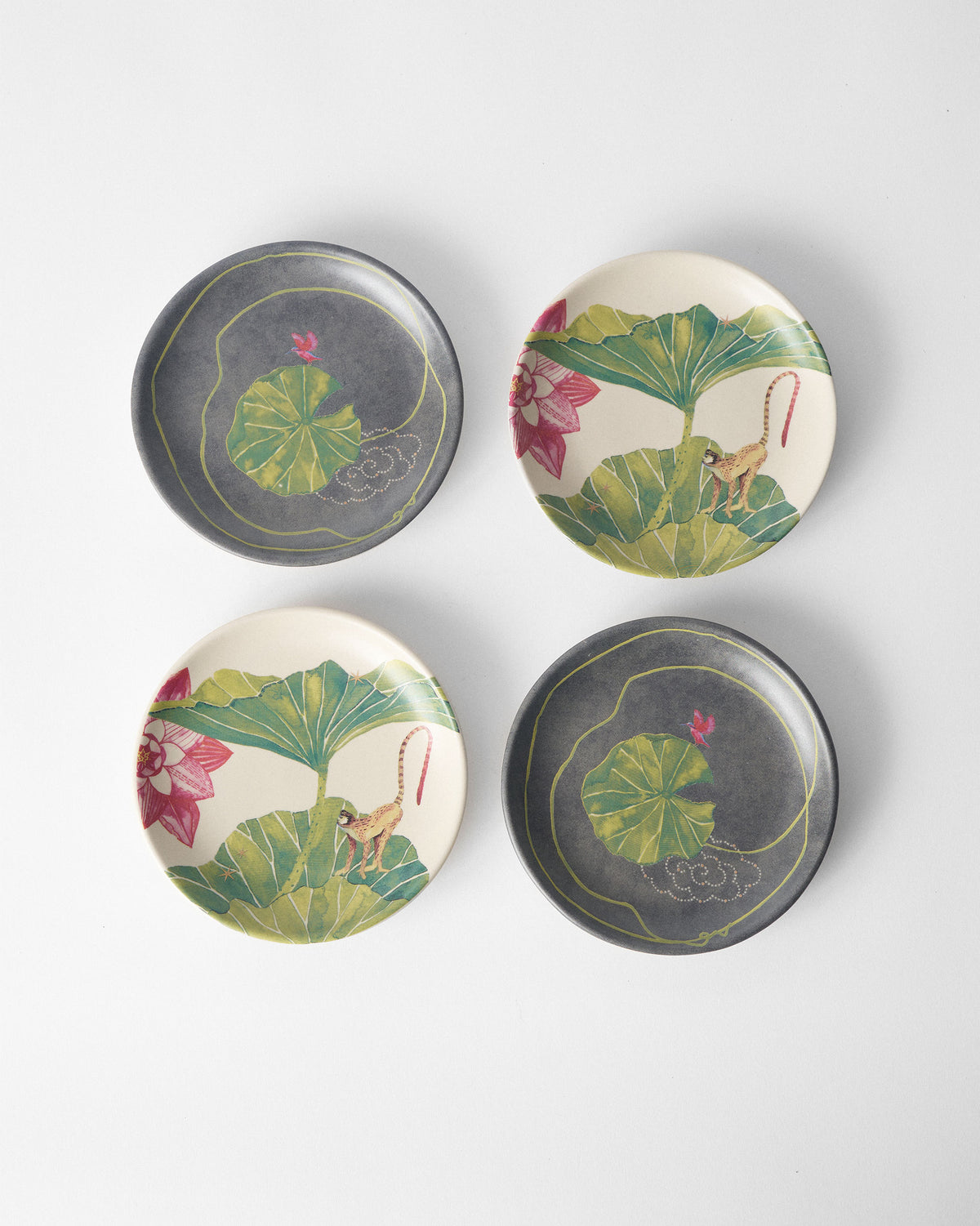 Set of four Float tea plates with lily pad and monkey lotus prints.