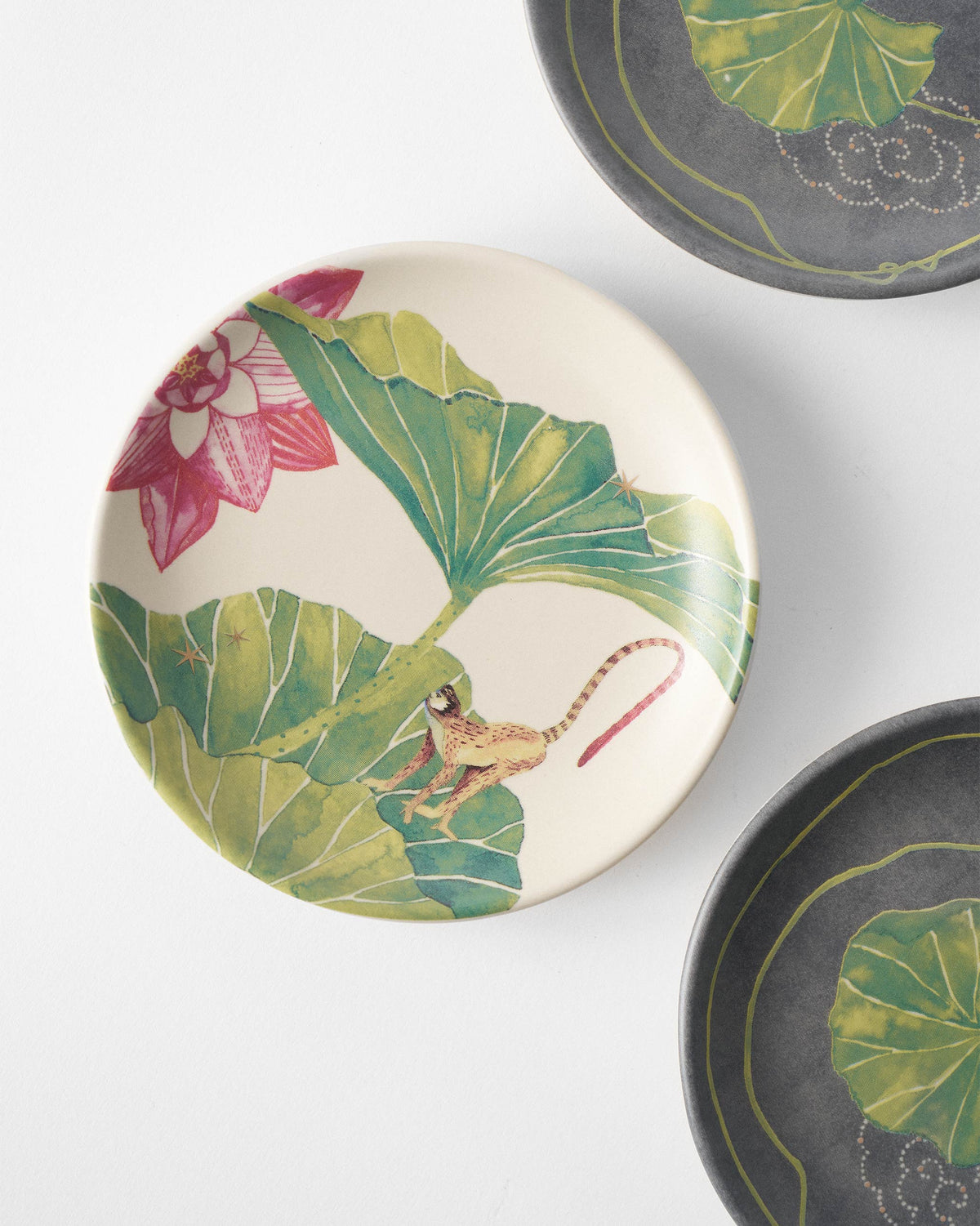 Float tea plate with a monkey on green lily pads and a pink lotus.