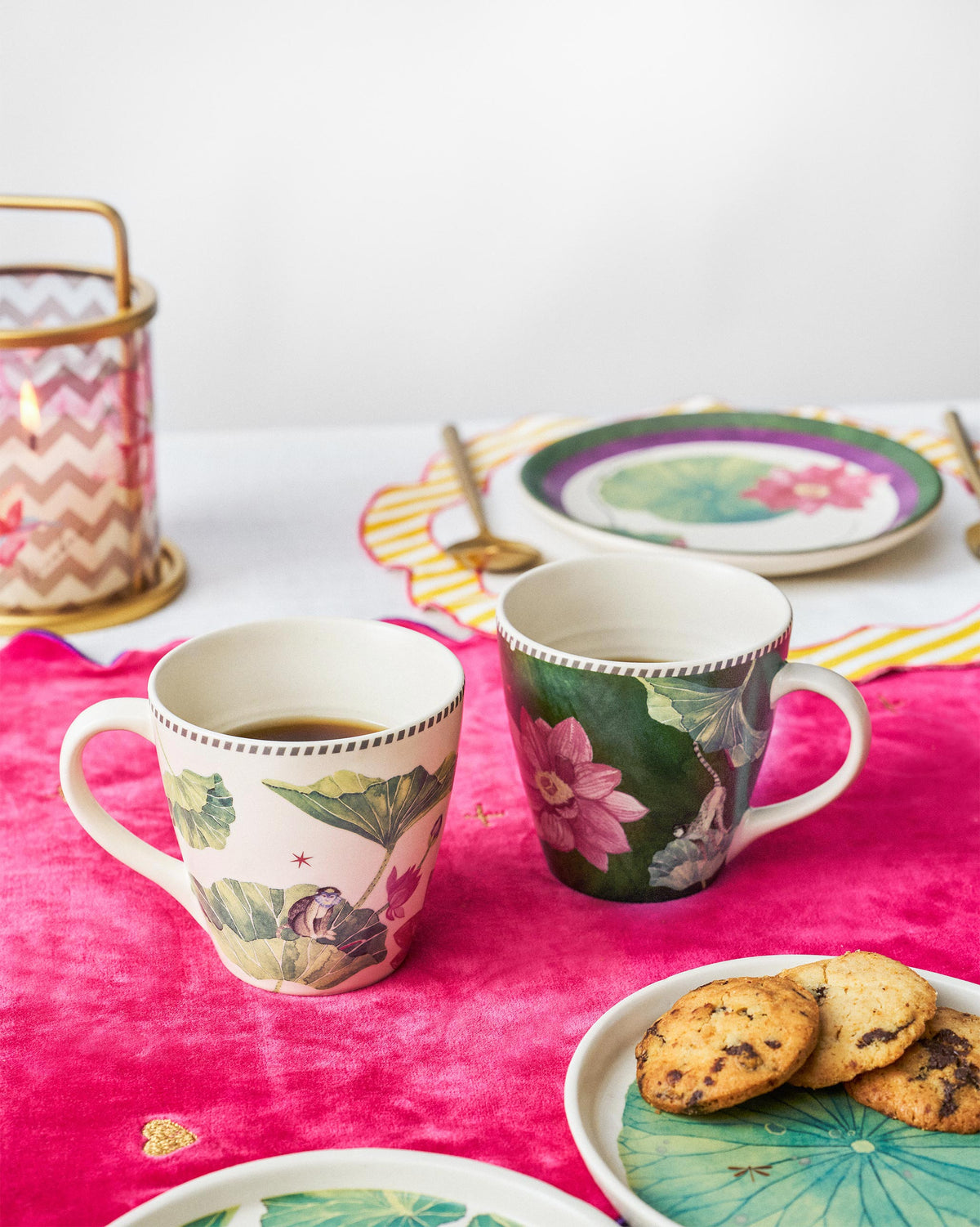 Pair of Float conical mugs with lotus prints on a table.