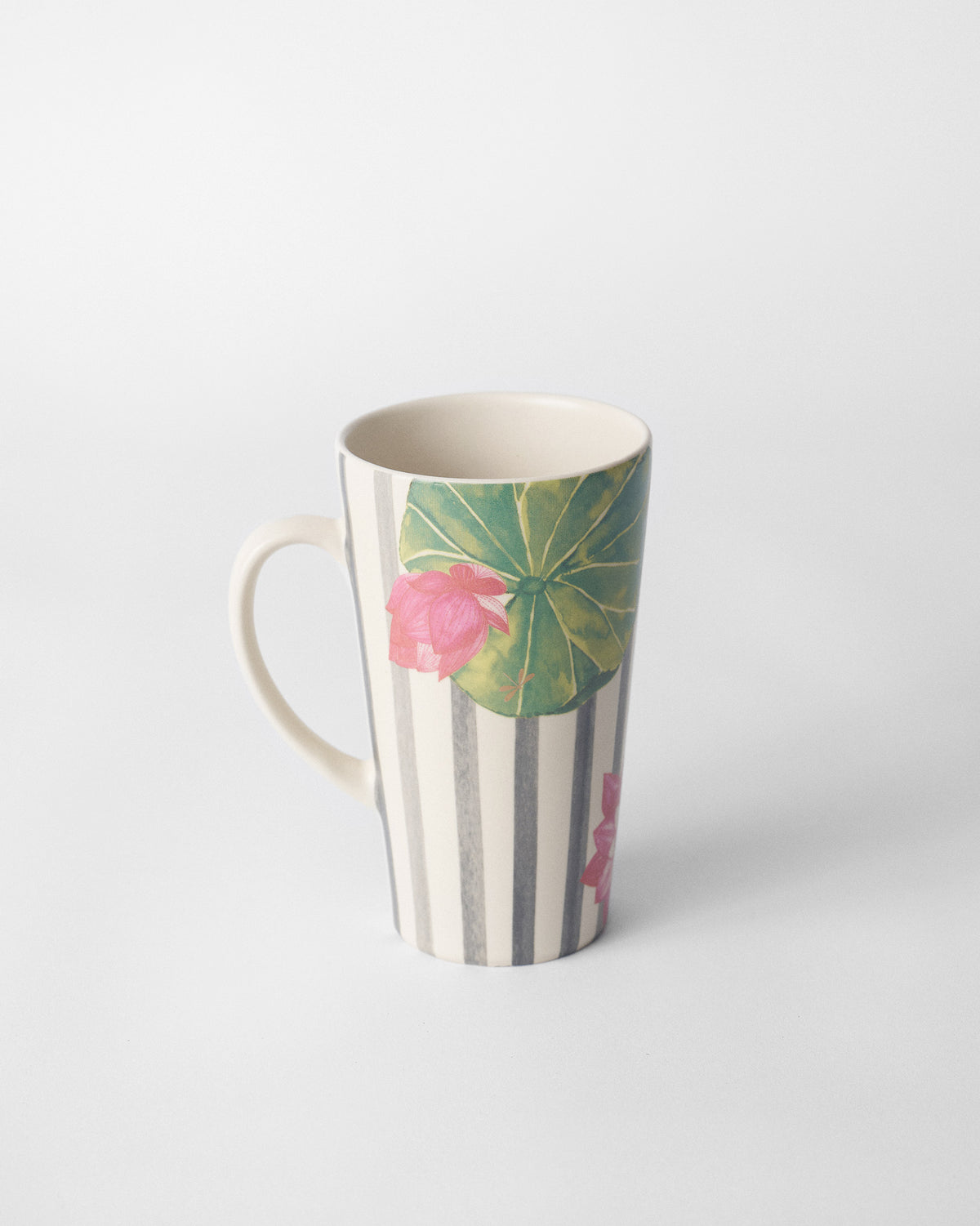 Float tall mug showing a green lily pad and pink lotus on charcoal stripes.