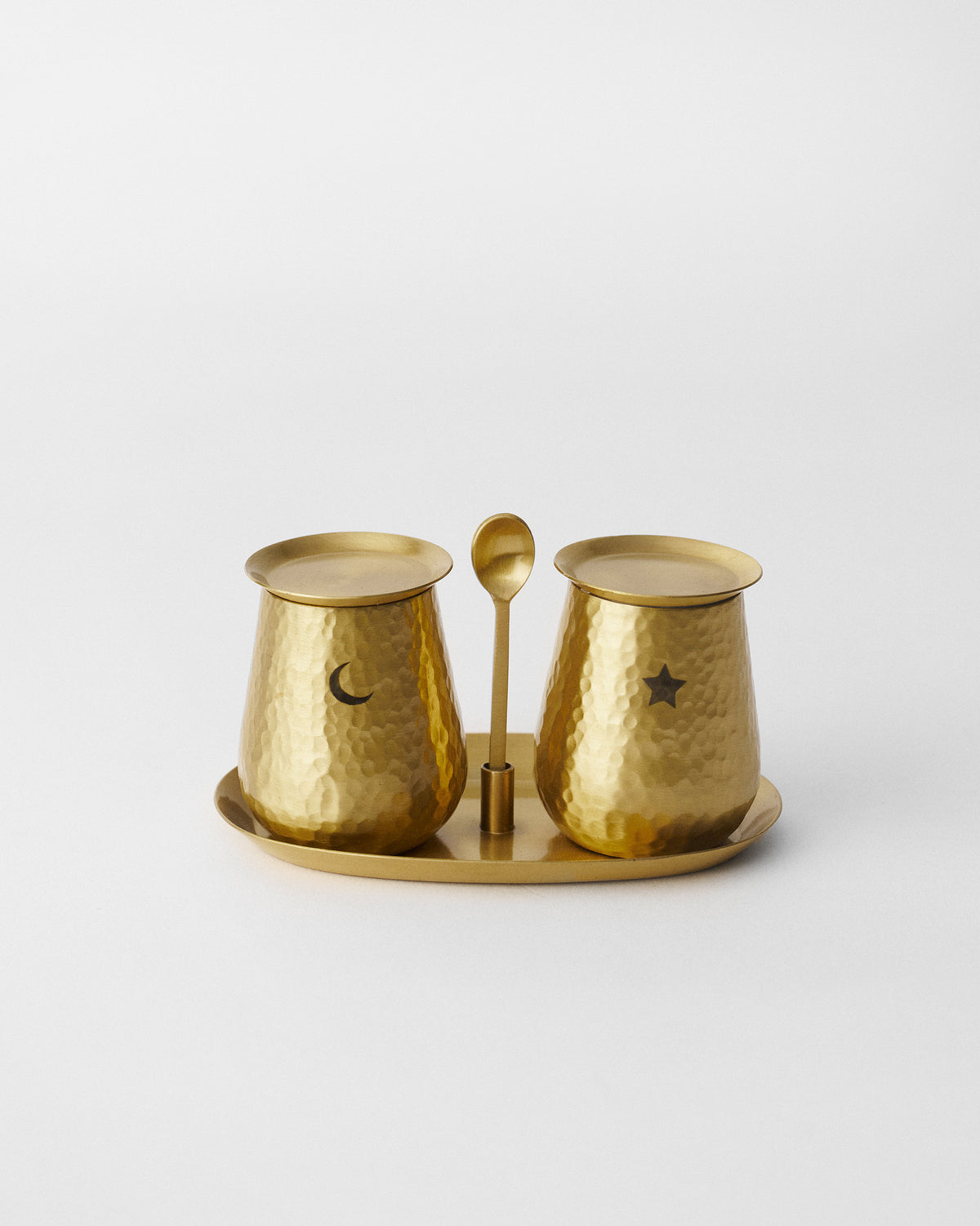 Gold Chand Sitara pots with moon and star cutouts on an oval tray.