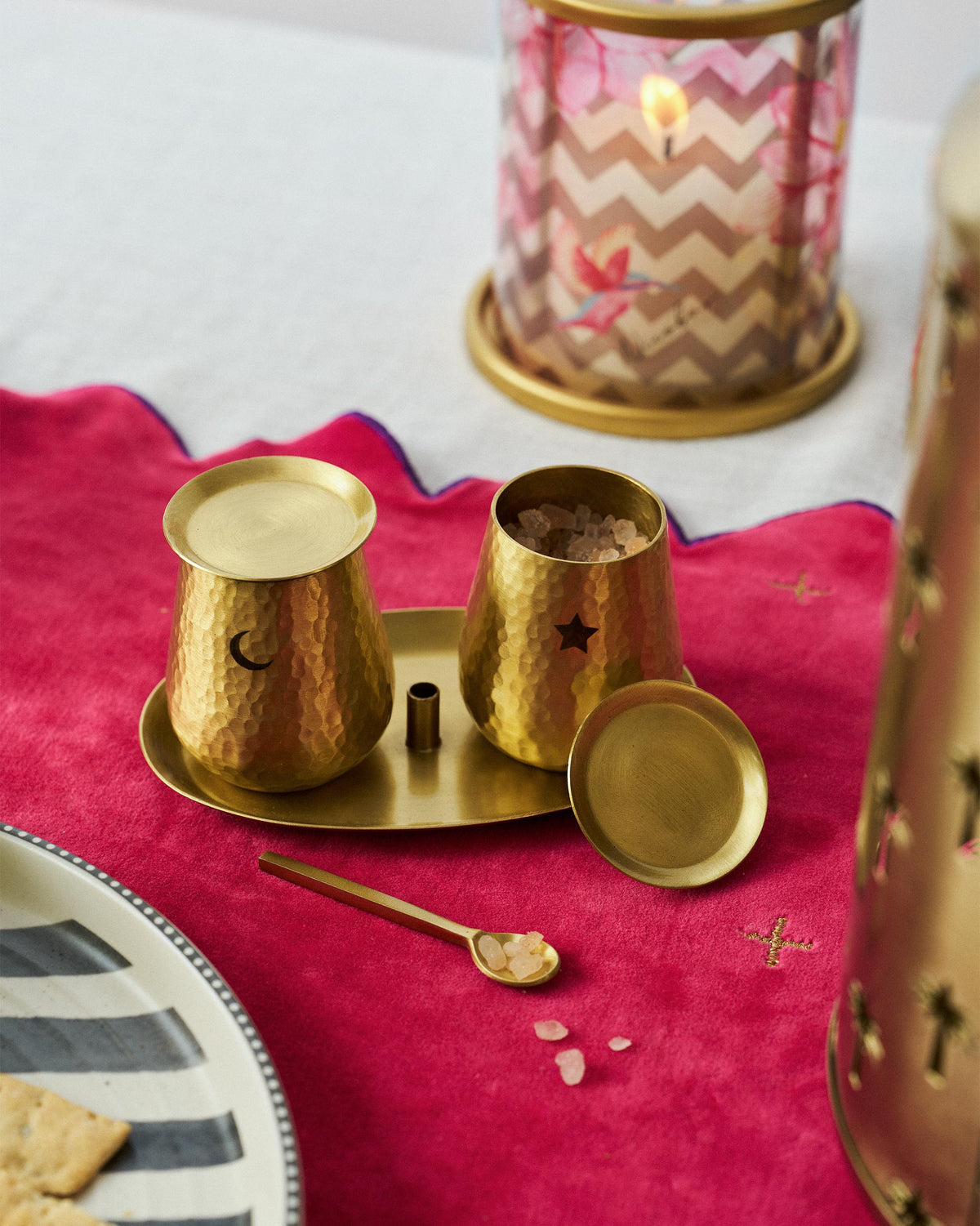 Chand Sitara salt and pepper set on a pink velvet table runner.