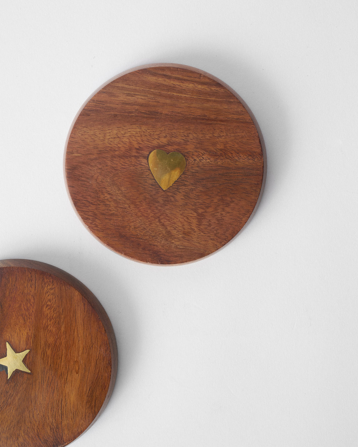 Overhead view of a wooden Aster lid with a brass heart inlay.