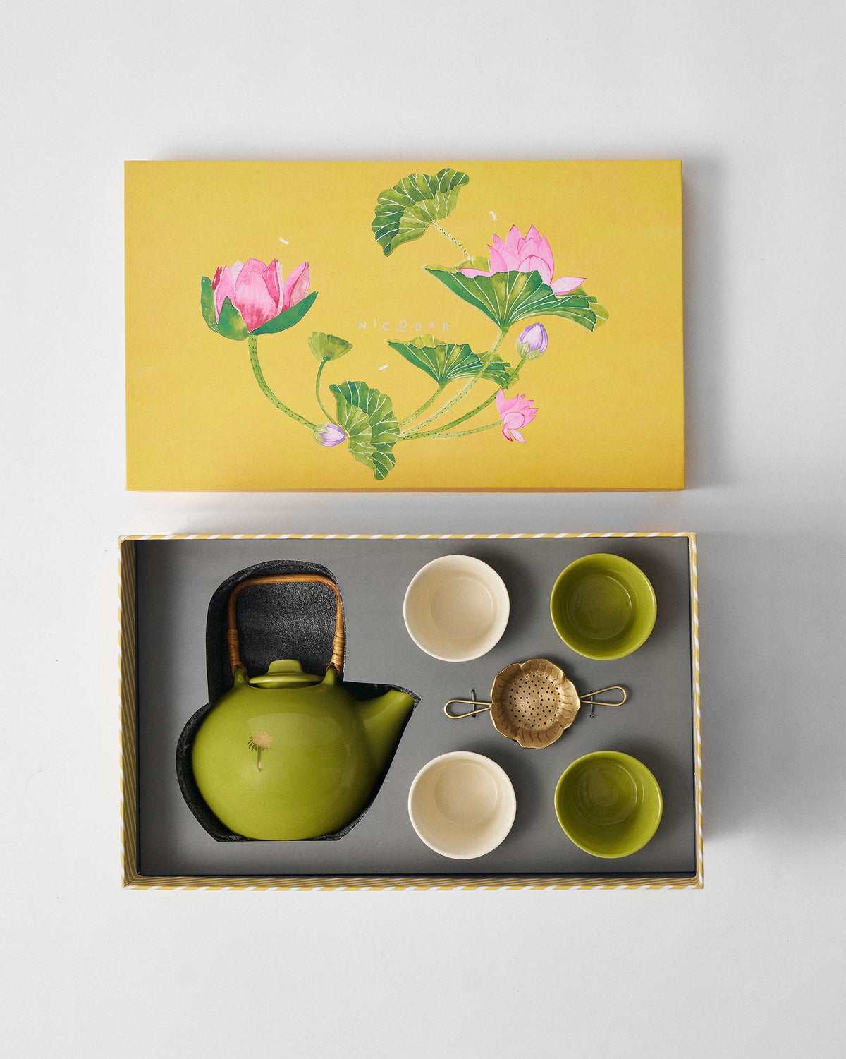 Float Tea Set nestled in its gift box under a yellow lotus-print lid.