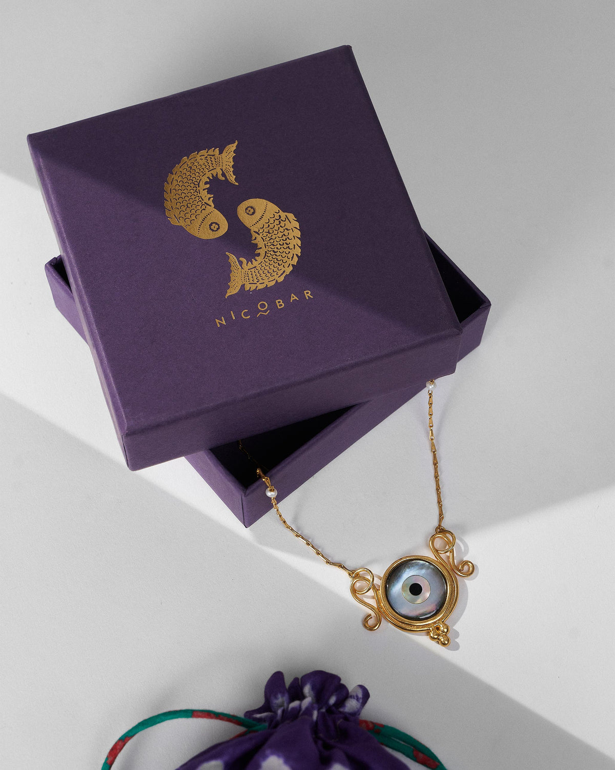 Gold Turki Nazar chain with a purple Nicobar gift box.