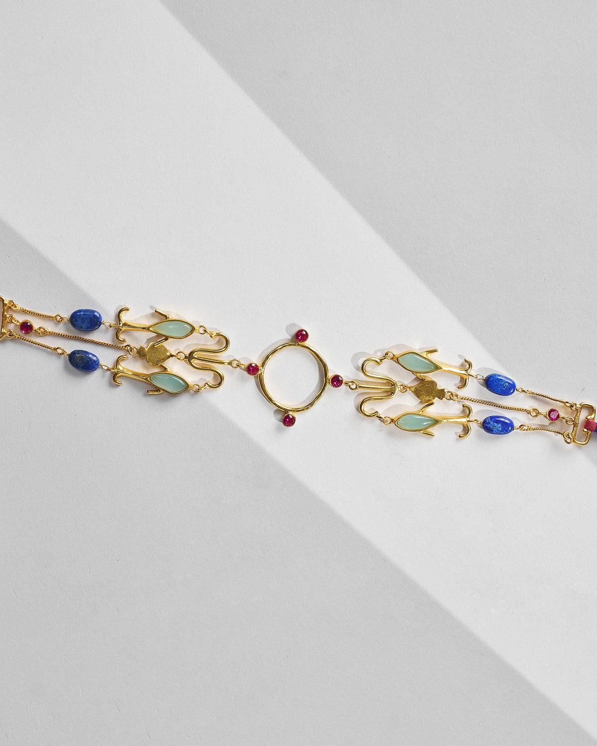 Gold Indus necklace centrepiece with lapis, pale green, and red stone accents.