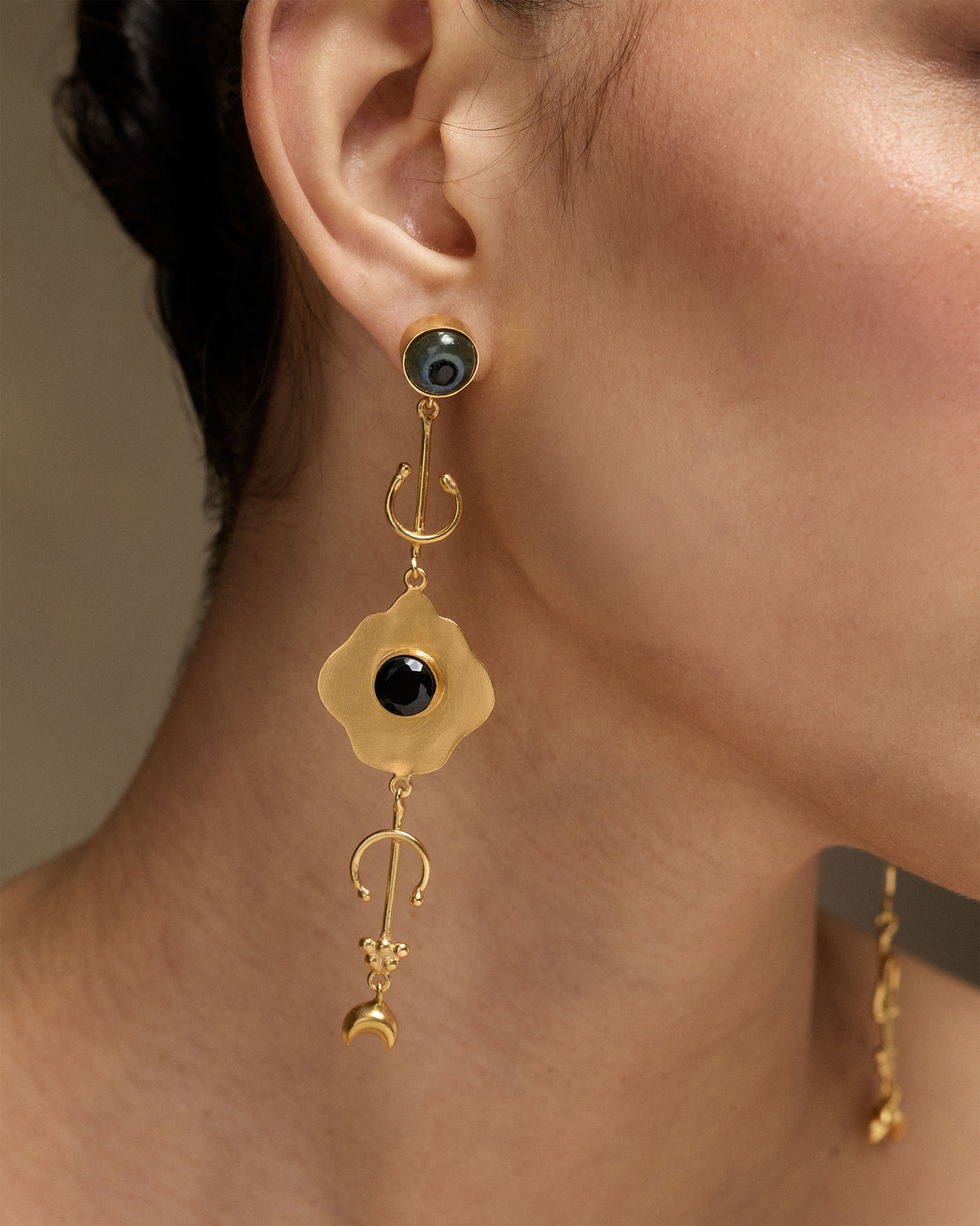 Close-up of Berber Eye Dangler worn, showing a black stone and gold crescent drops.