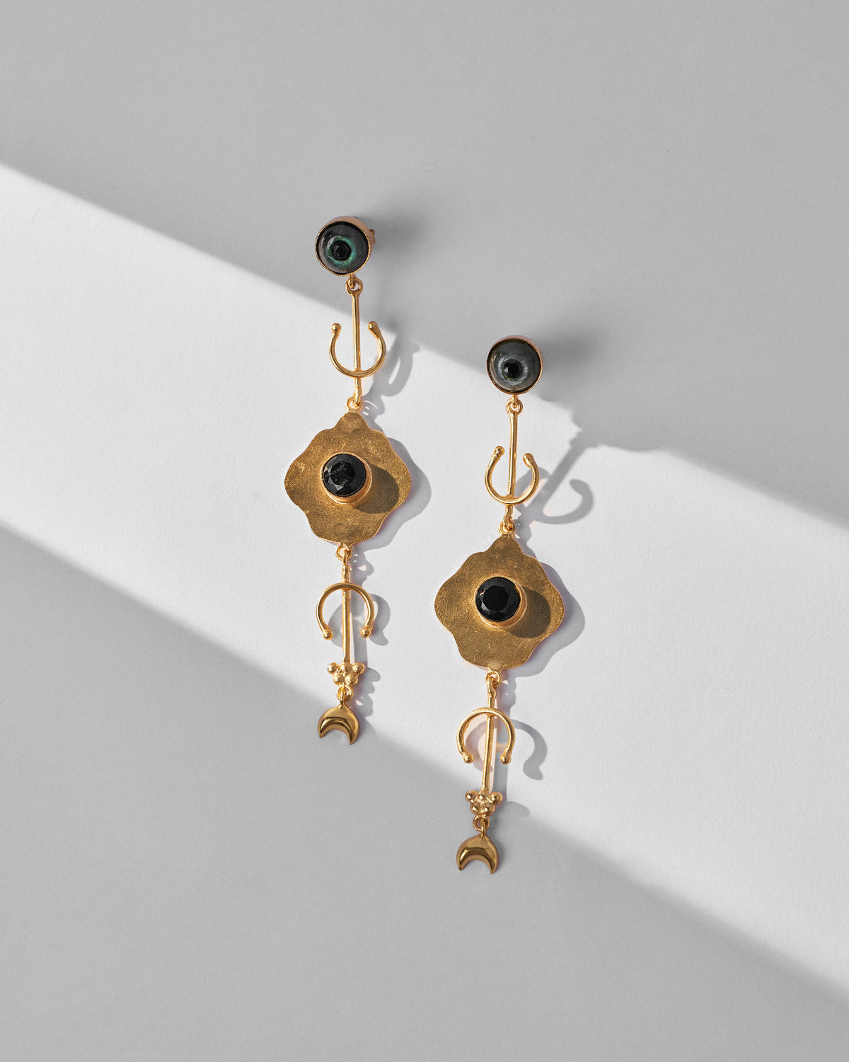 Pair of Berber Eye Dangler on a grey surface, with black stone centres.