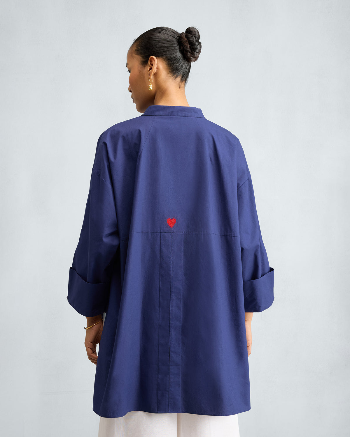 Back of the ink blue Cirrus Shirt with a small red heart.