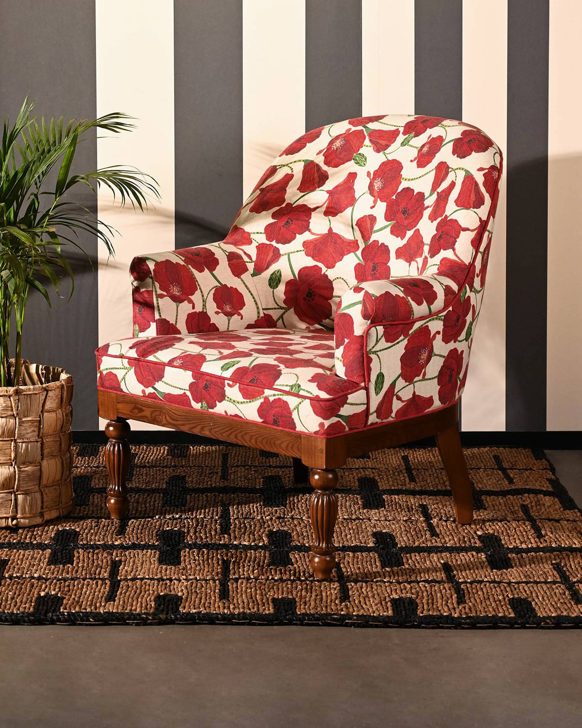 Meadow Chair in red poppy upholstery on a woven rug.