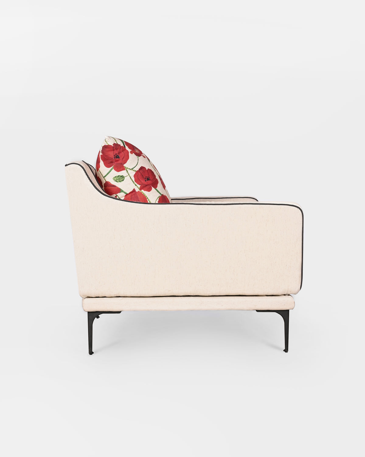 Side view of a cream Field lounge chair with a red poppy cushion.