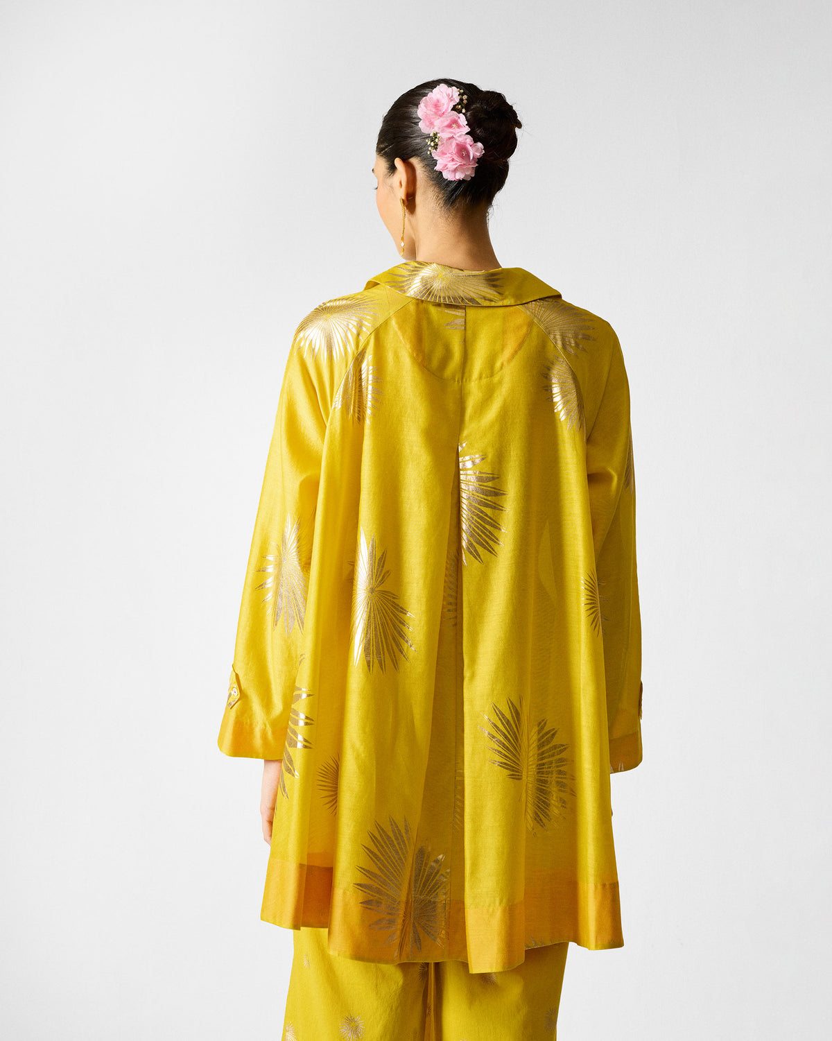 Back of a chartreuse Flare Panelled Shirt with gold palm prints.