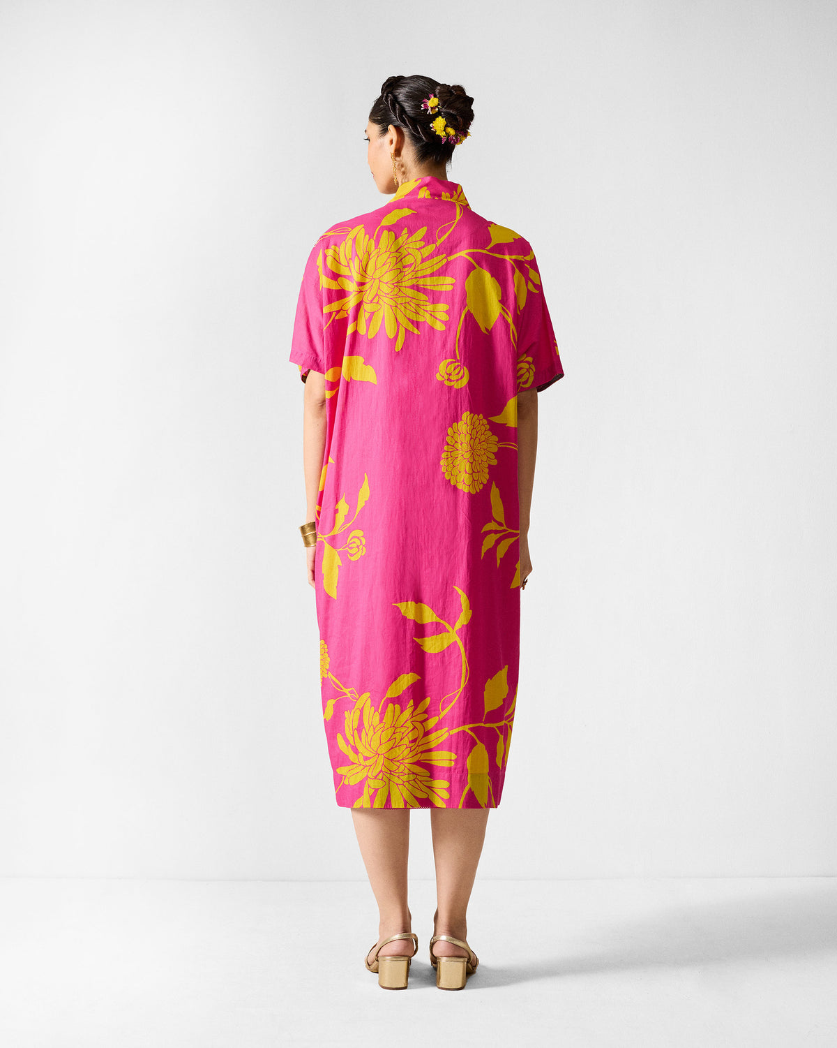 Back of a fuchsia Doda dress with lime abstract floral print.