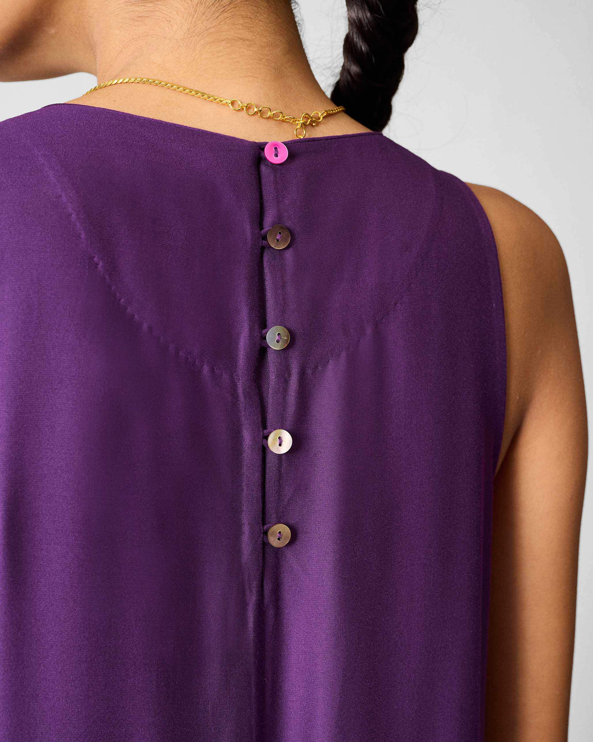 Close-up of the back buttons on a purple Amreli jumpsuit.