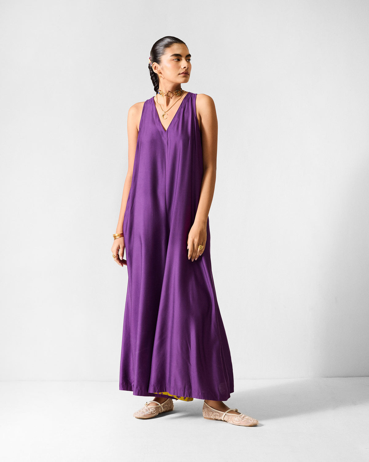 Person wearing a purple Amreli jumpsuit with a deep V-neck.