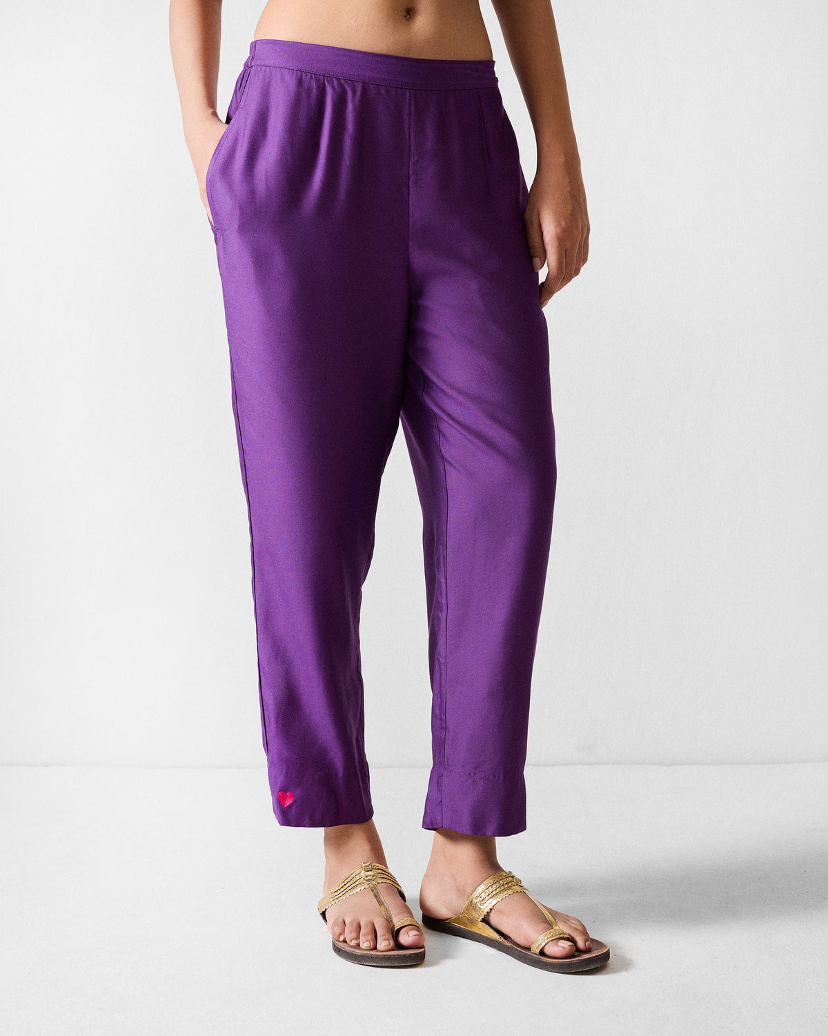 Purple Darjeeling pants with a straight cropped fit and a small red heart near the hem.