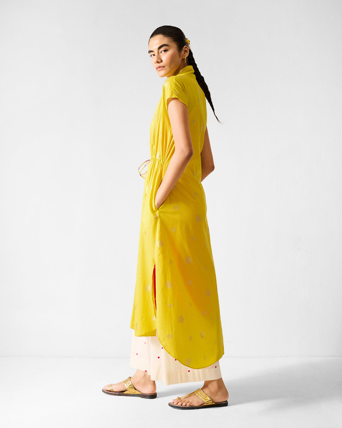 Side view of a chartreuse Myra overlay with side slits and a high-low hem.