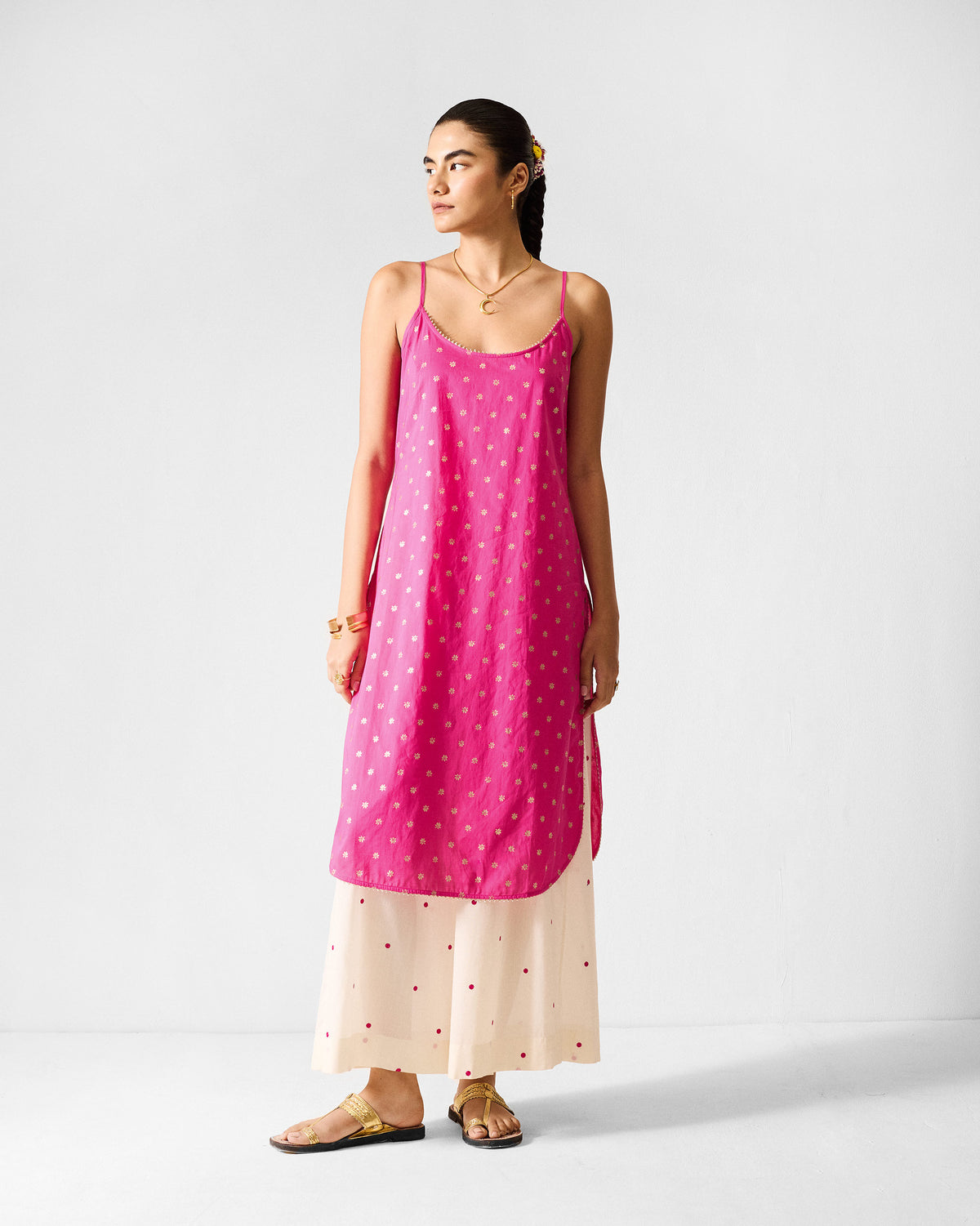 Person wearing a fuchsia Vintage Camisole with gold printed dots.