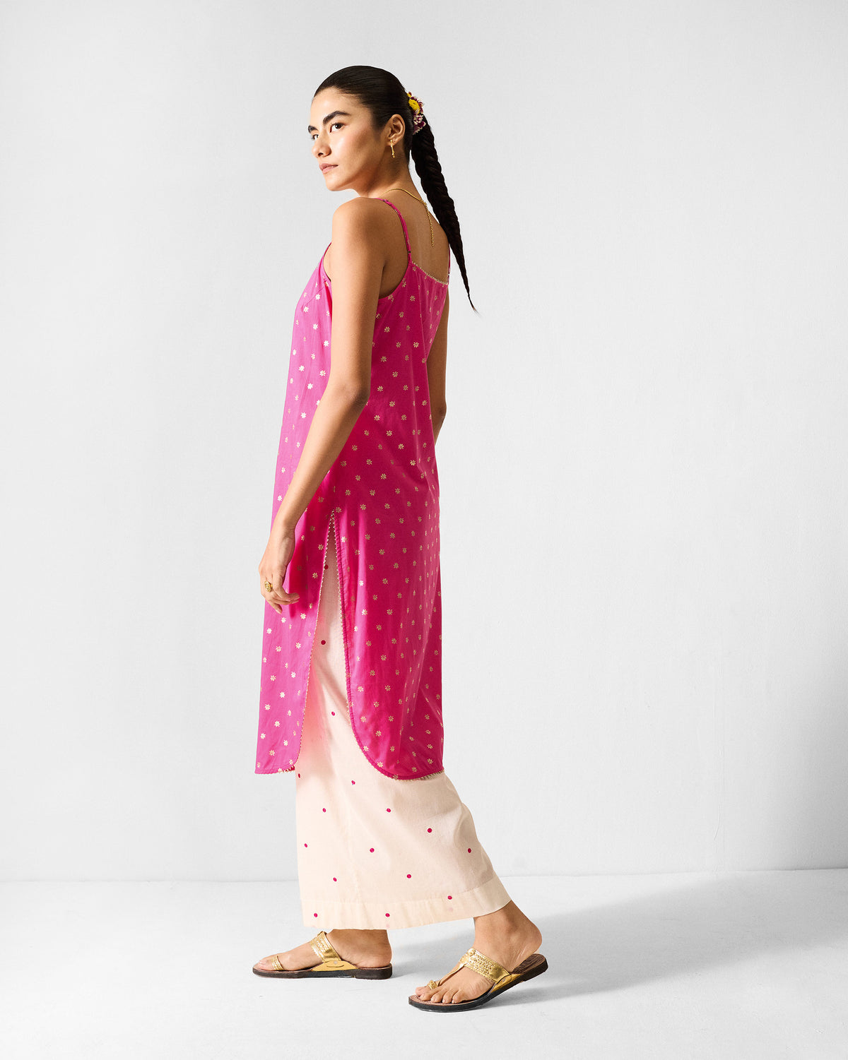 Side view of a fuchsia Vintage Camisole showing its side slits and length.