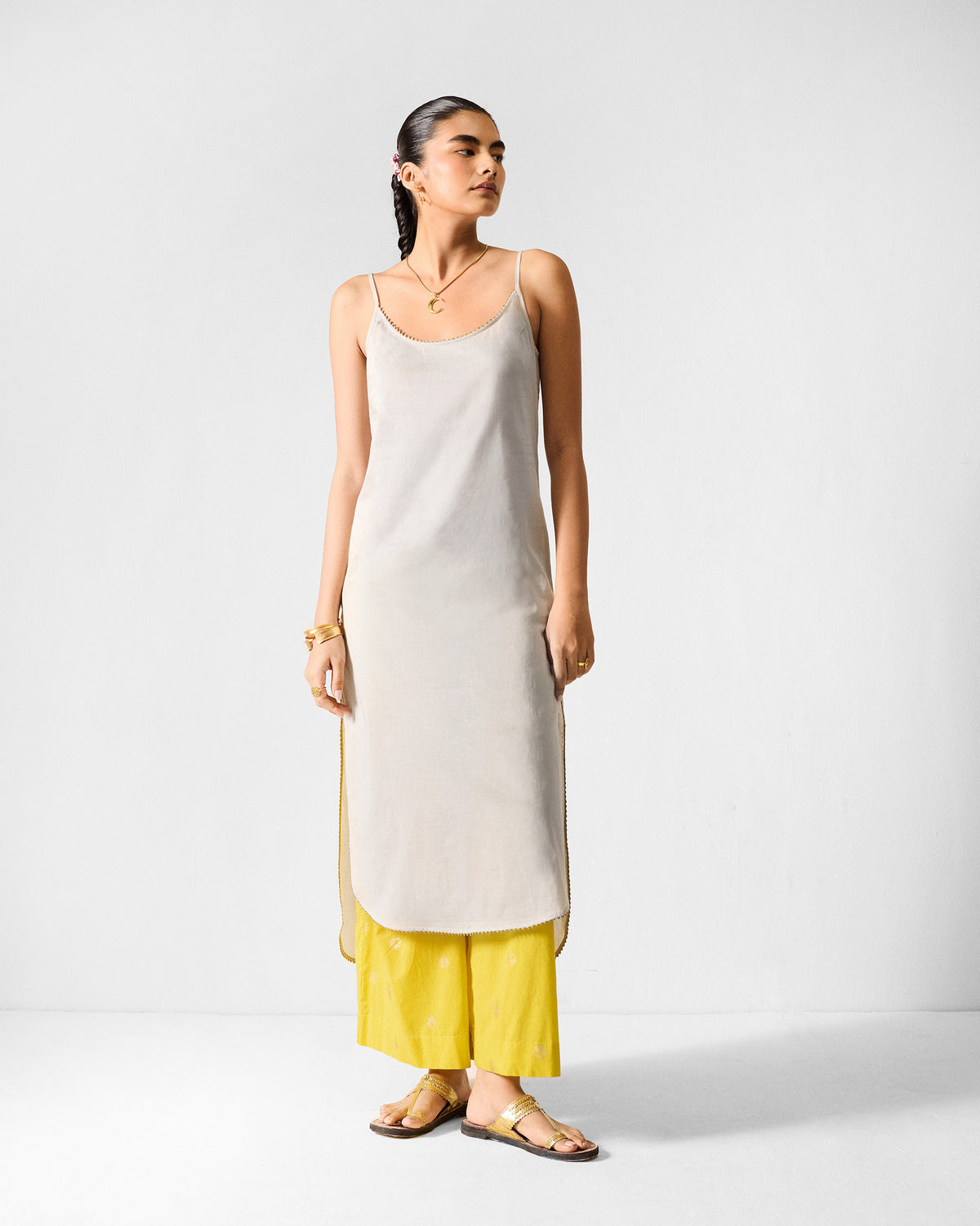 Person wearing a grey Kumaon Slip with thin straps and a high side slit.