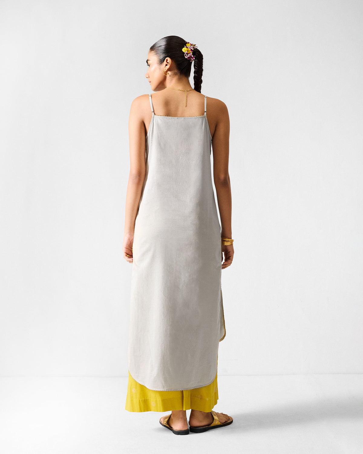 Back of a grey Kumaon Slip with thin straps.