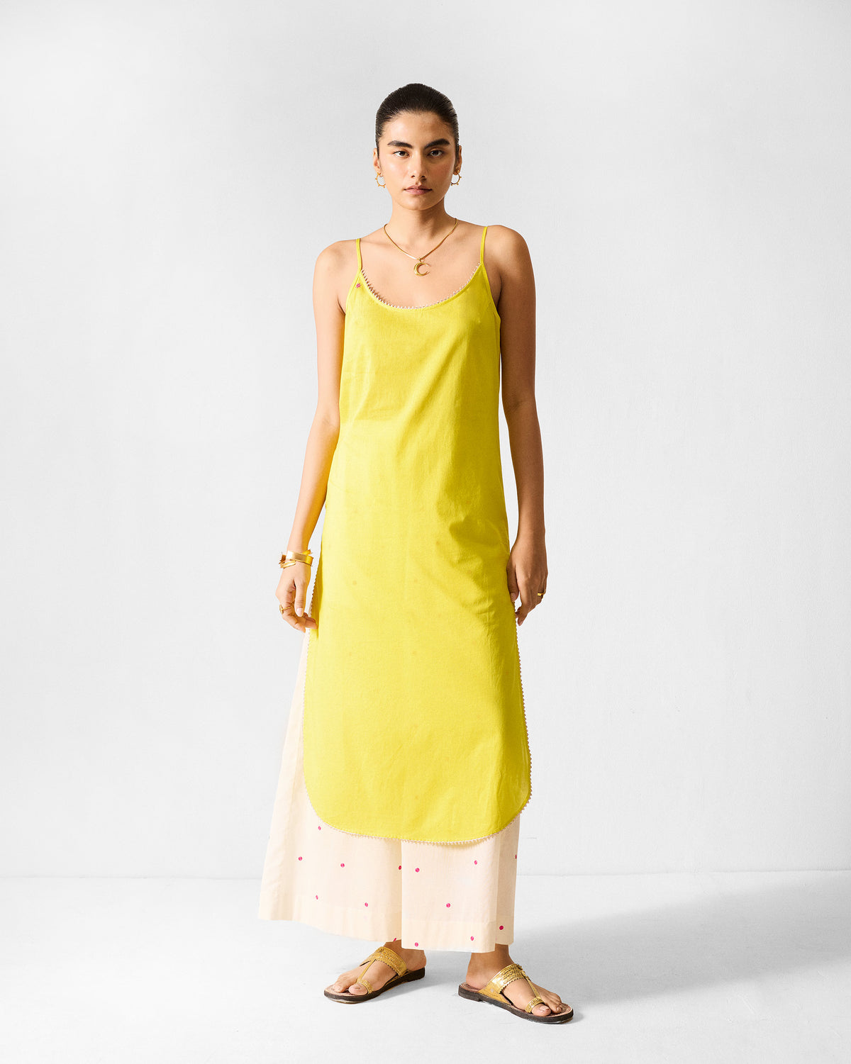 Person wearing a lime Kumaon slip with thin straps.