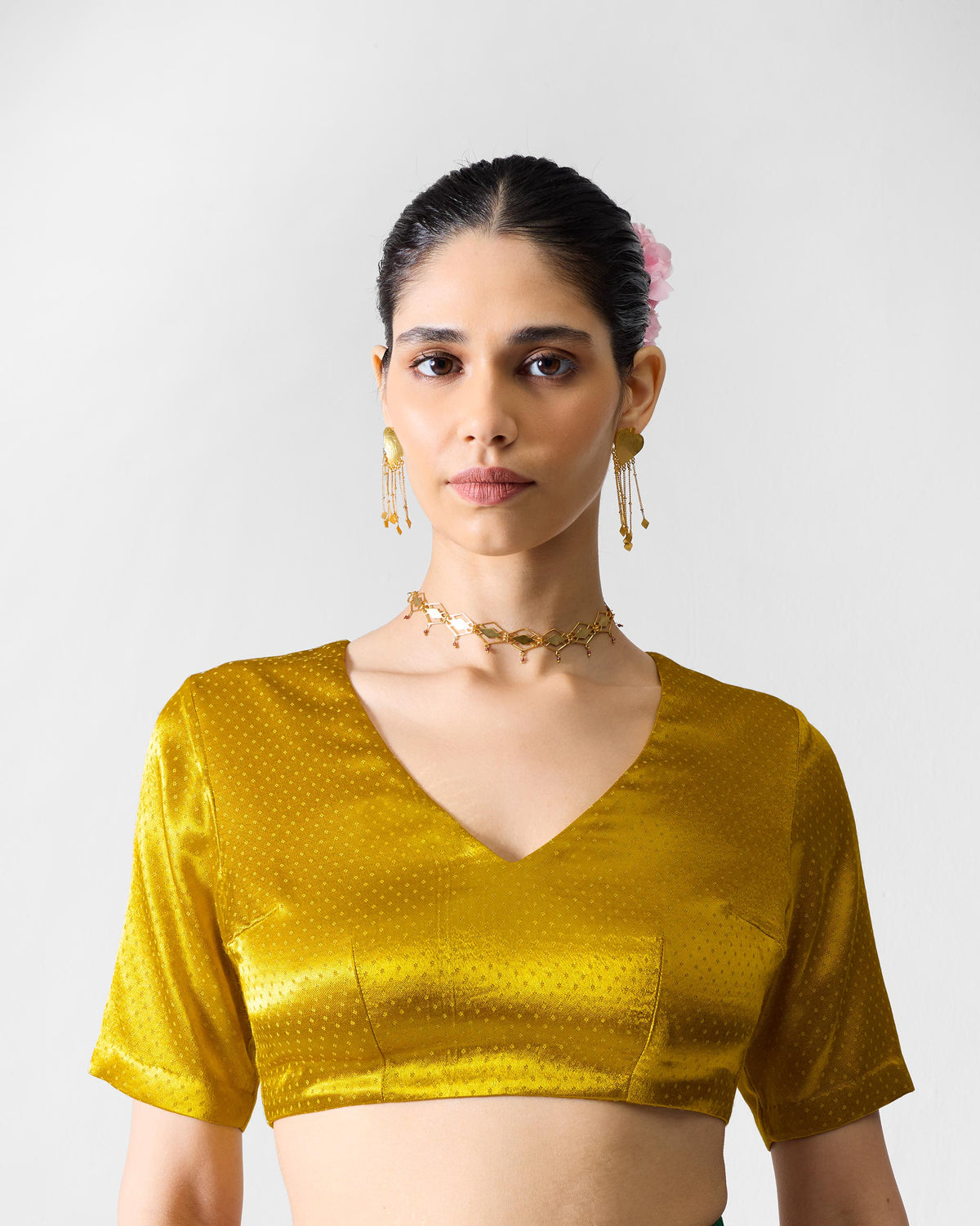 Person wearing a Dori blouse with a V-neck and short sleeves.