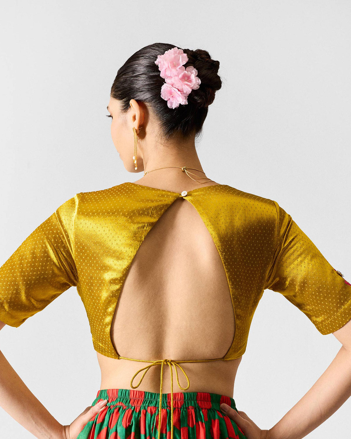 Back of a Dori blouse with an open back and tie closure.
