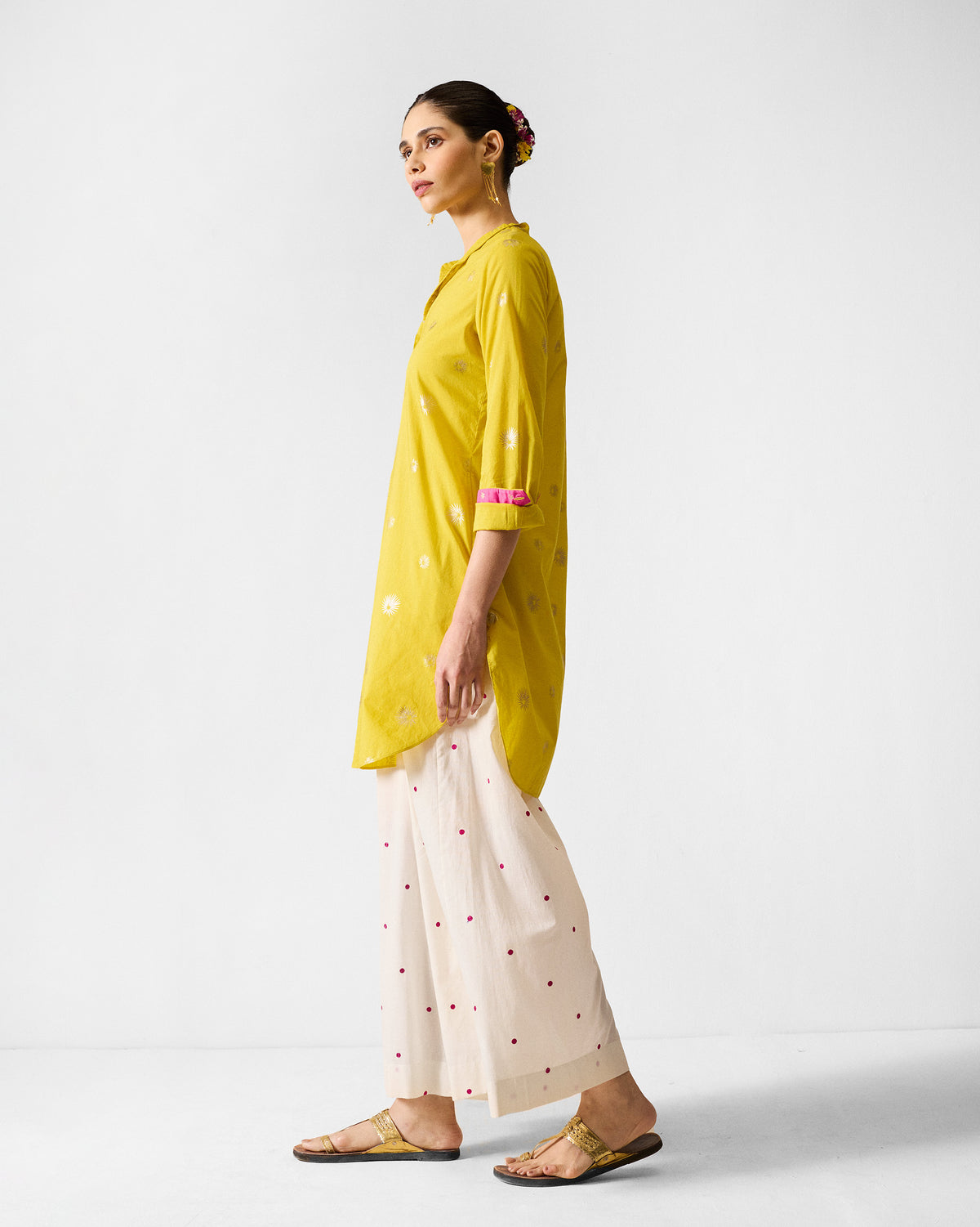 Side view of a chartreuse mid-length kurta with a side slit.