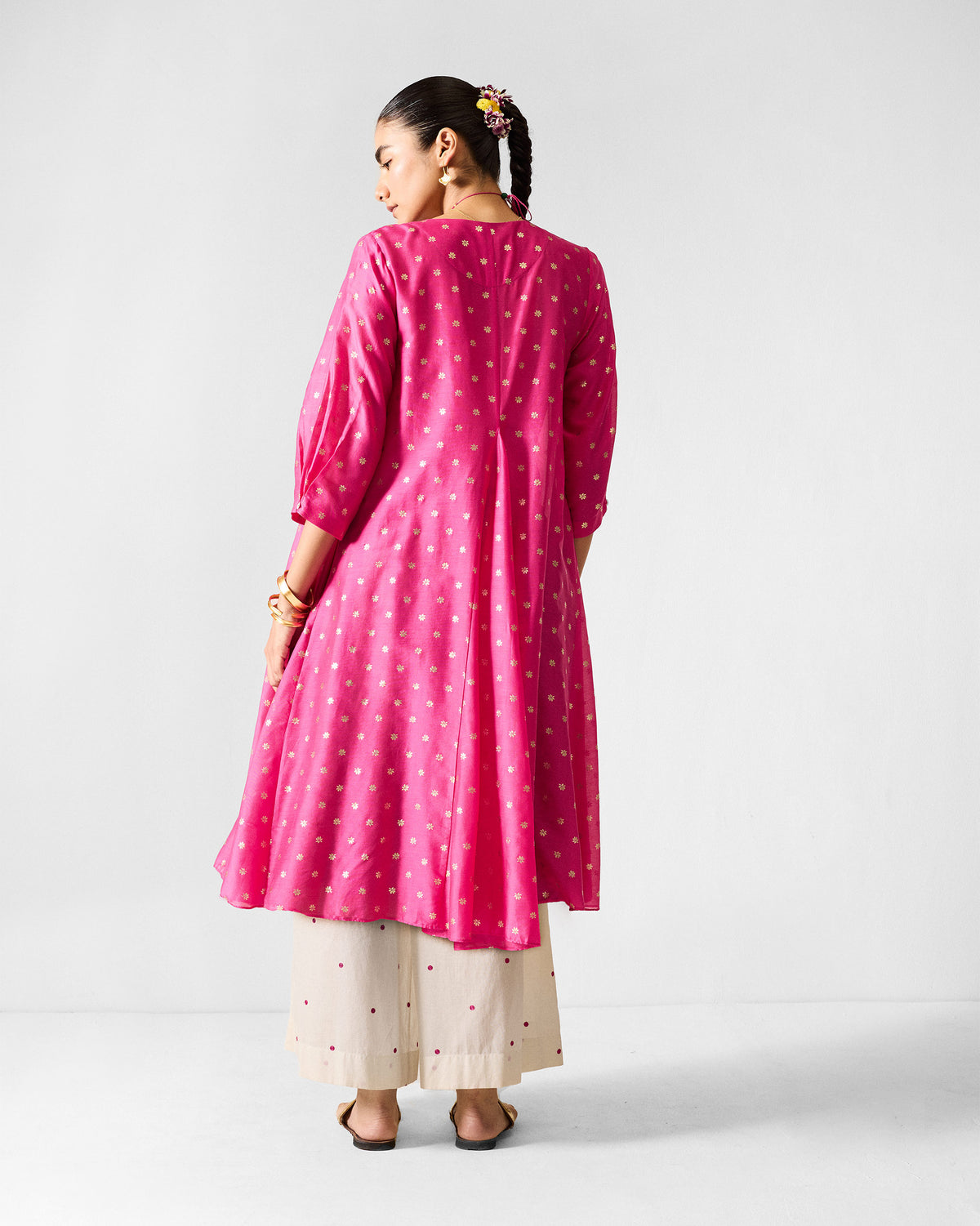 Back of a fuchsia Kannauj Kurta with gold floral prints.