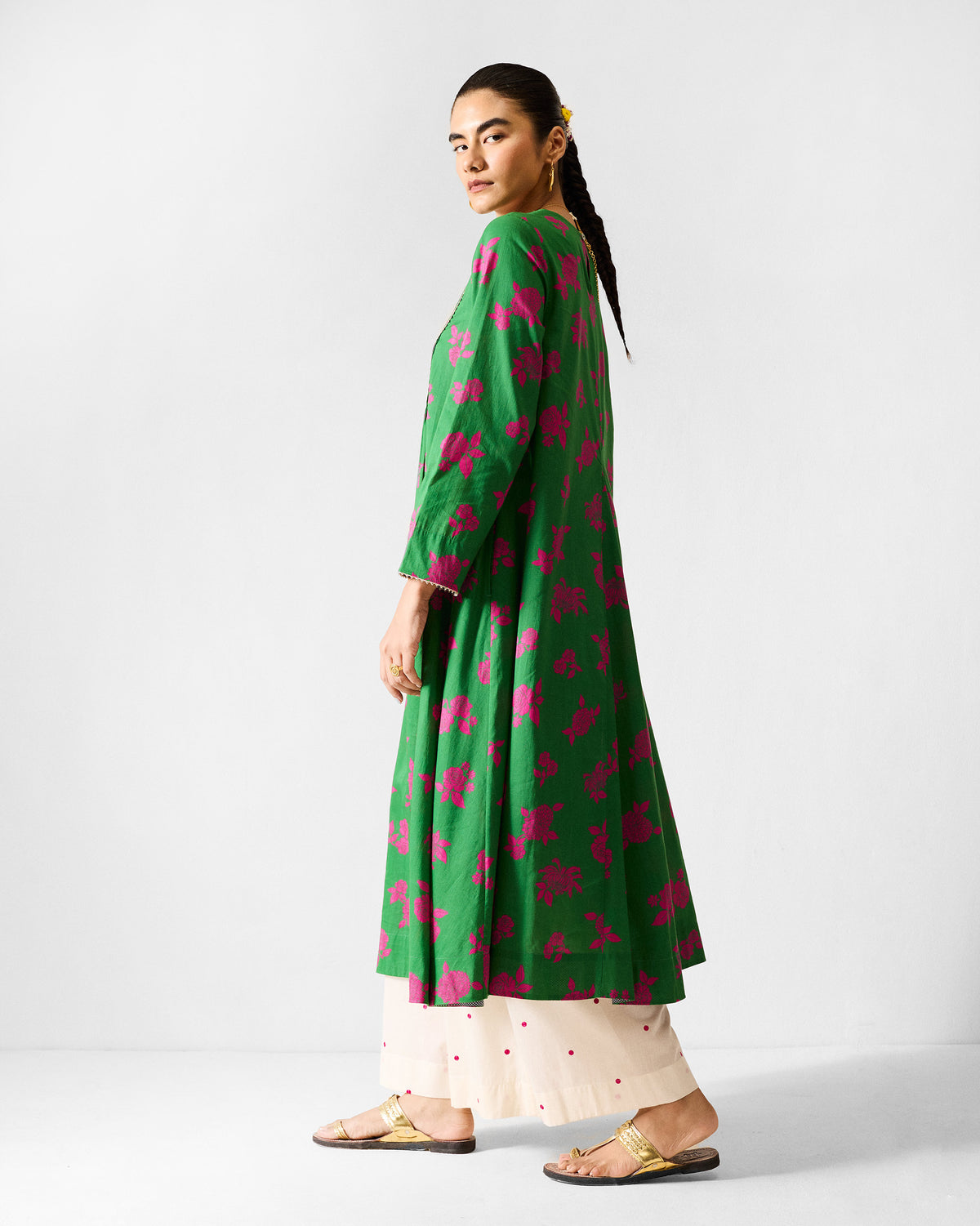 Side view of a green and fuchsia printed Ayat kurta with a flared hem.