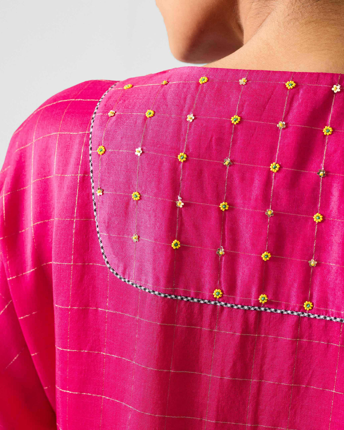 Close-up of embroidered back yoke on a fuchsia Luna Afghan Kurta.