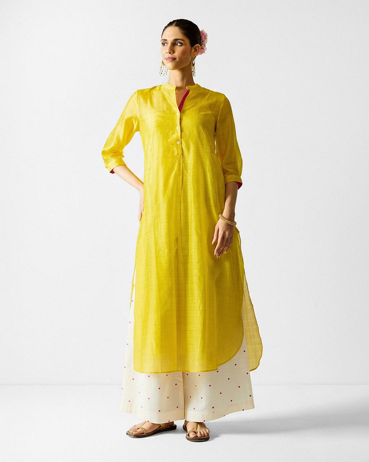 Person wearing a lime and gold checked Kumaon Kurta with a band collar.