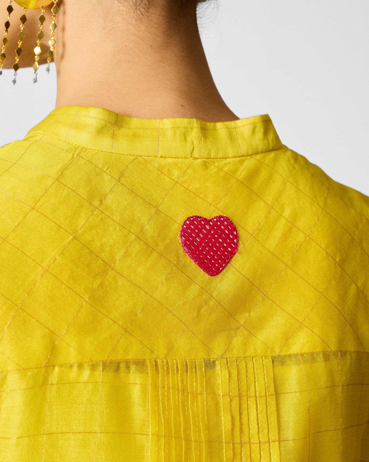 Close-up of a Kumaon Kurta showing a pink embroidered heart on the back.