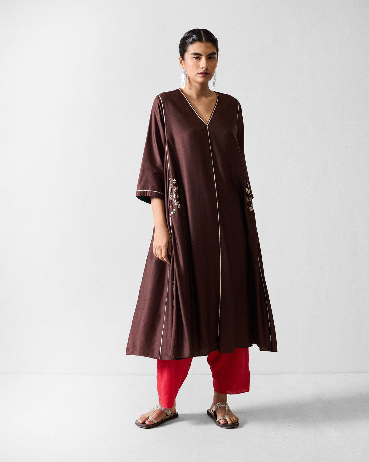 Full-length view of a chocolate brown Aheli kurta with white piping.