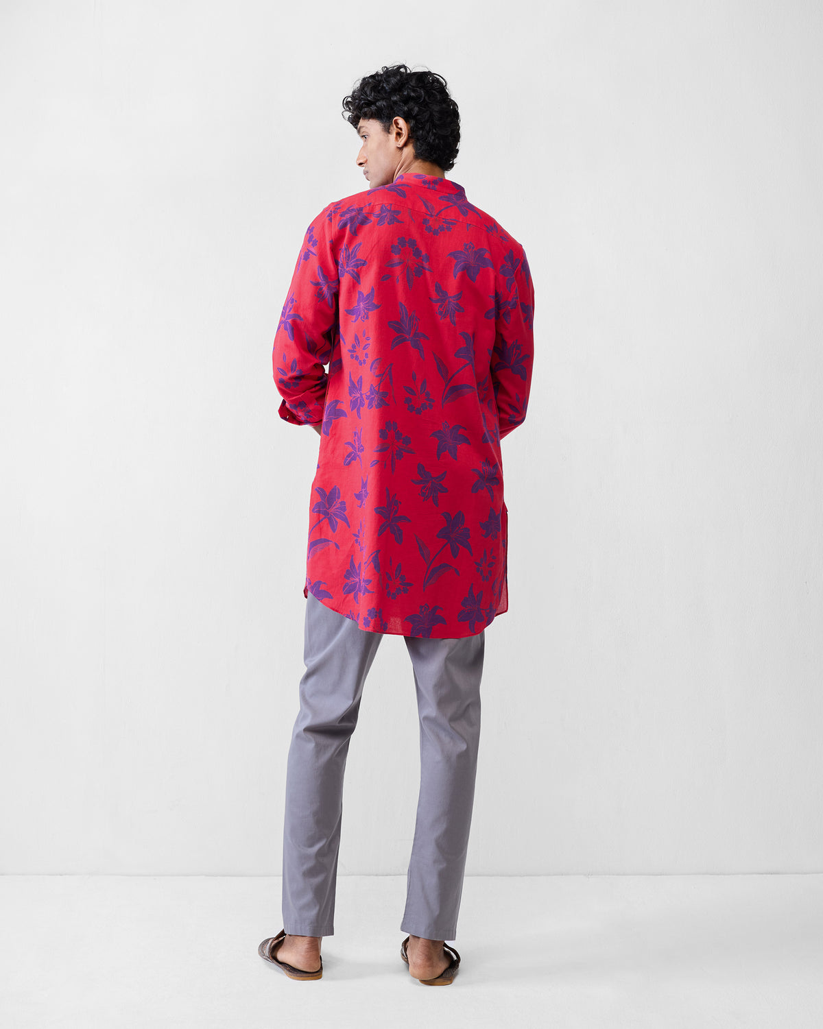 Back of a red Fort kurta with a purple lily print.
