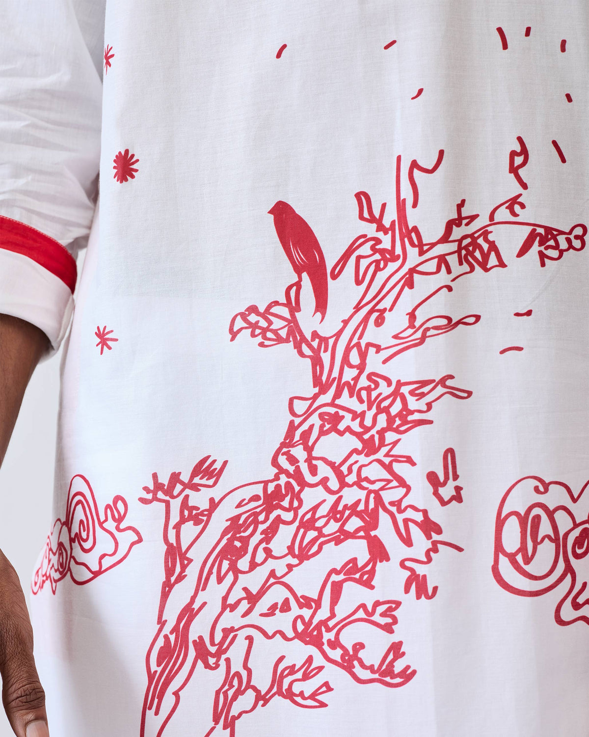 Close-up of a white Neckband Kurta showing a red tree and bird print.