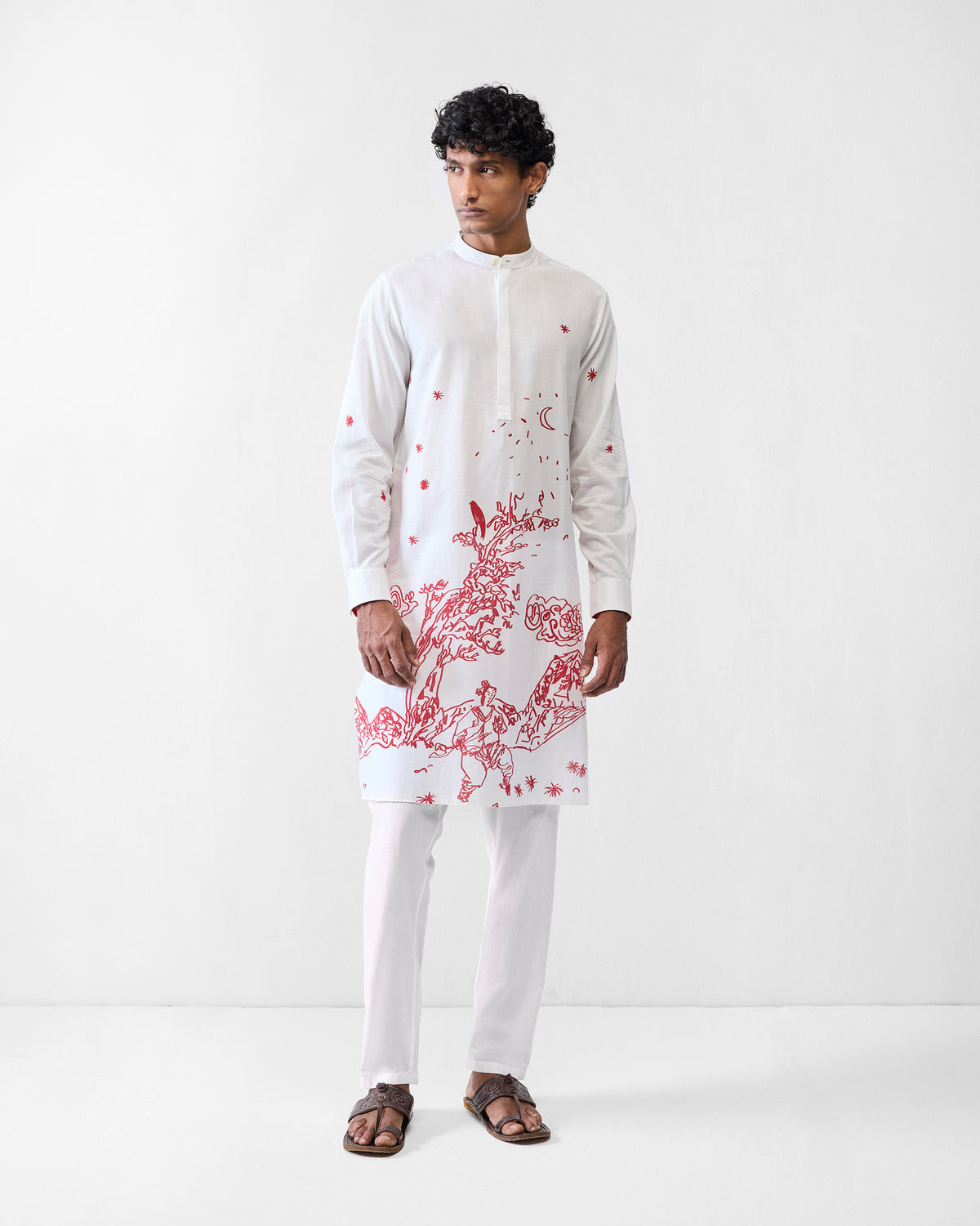 Person wearing a white Neckband Kurta with a red landscape print and Nehru collar.