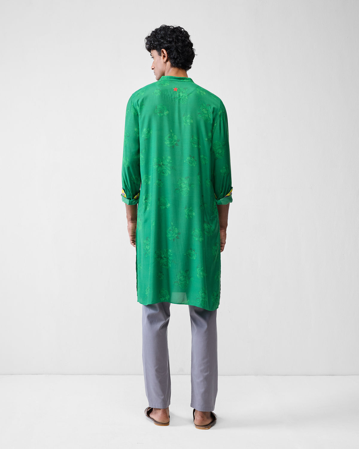 Back of an emerald green Astral kurta with tonal rose print.