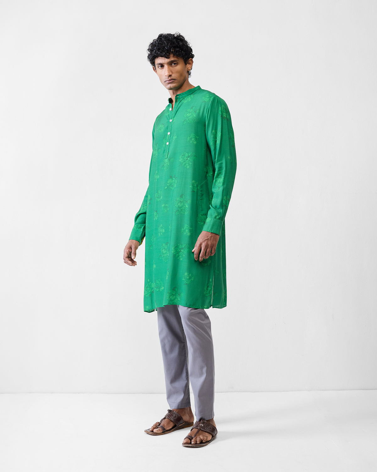 Person wearing an emerald green Astral kurta with tonal rose print.