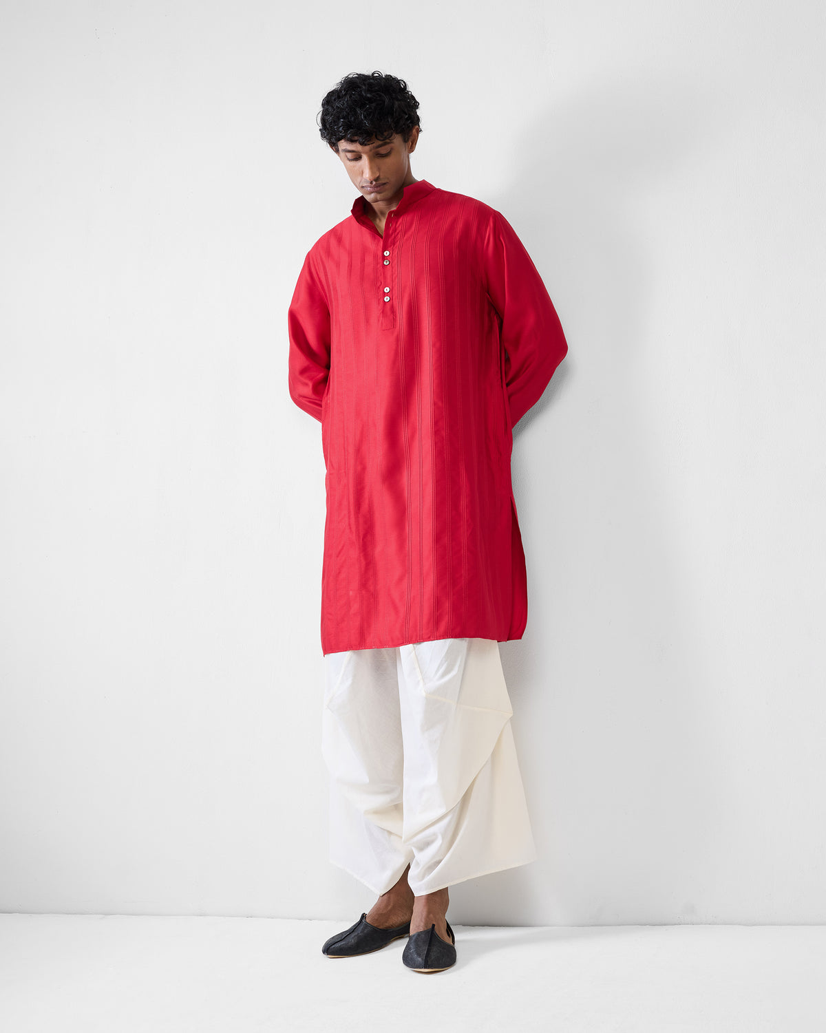 Person wearing a red Long Pleated Kurta showing mid-thigh length.